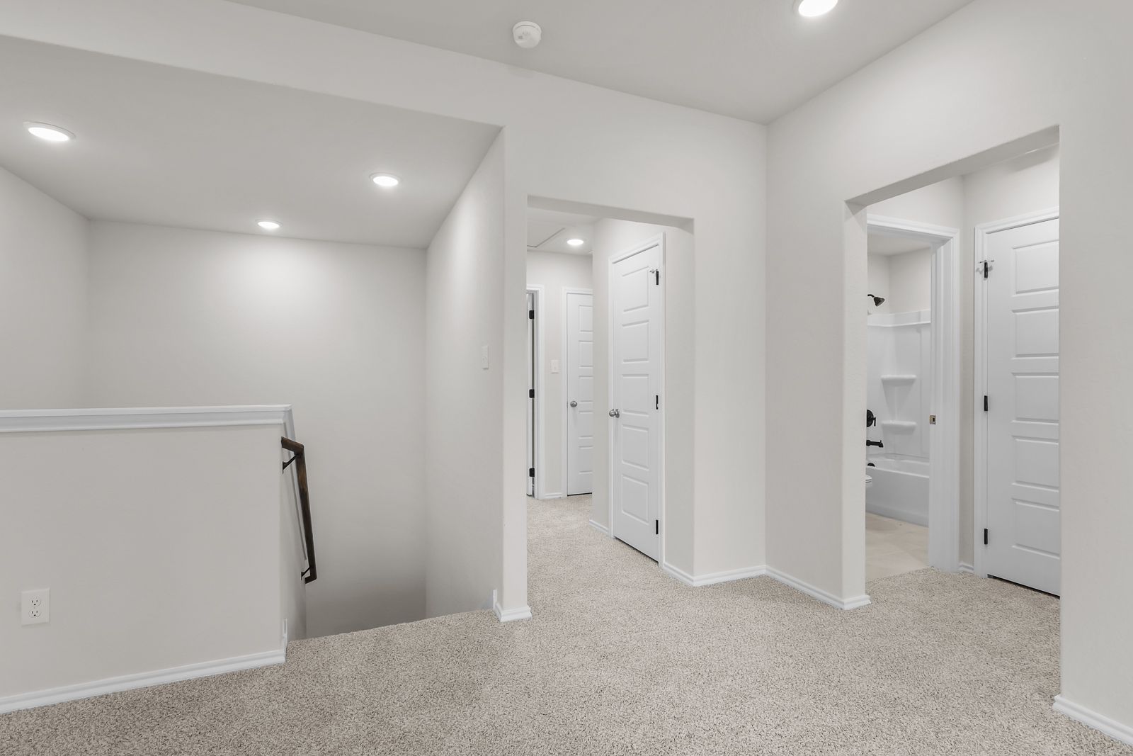 Second-floor landing and hallway of The Sequoia C, featuring plush carpeting and access to bedrooms and a full bathroom.