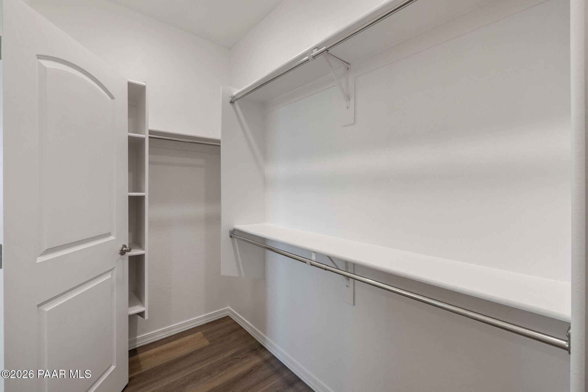 Spacious walk-in closet with built-in shelves and hanging rods in Davidson Homes The Frontier A, Prescott Valley, Arizona