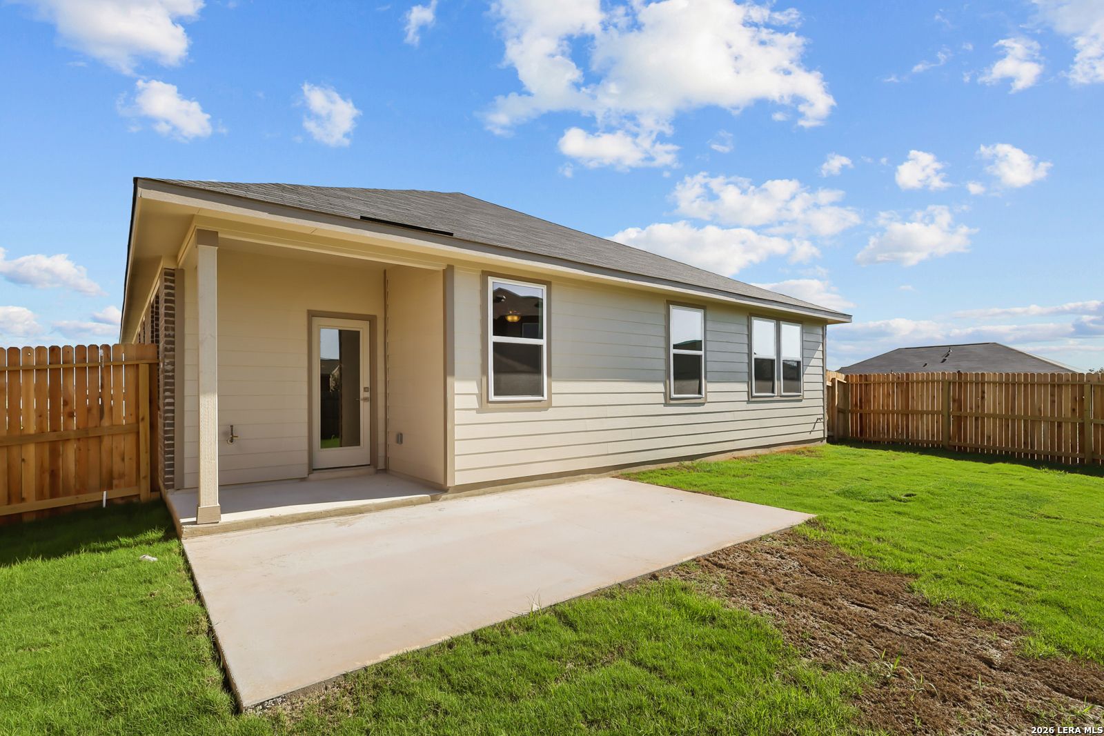 Covered back patio and fenced backyard of The Daphne I, a 4-bedroom Davidson Homes new construction in Bricewood, San Antonio, Texas
