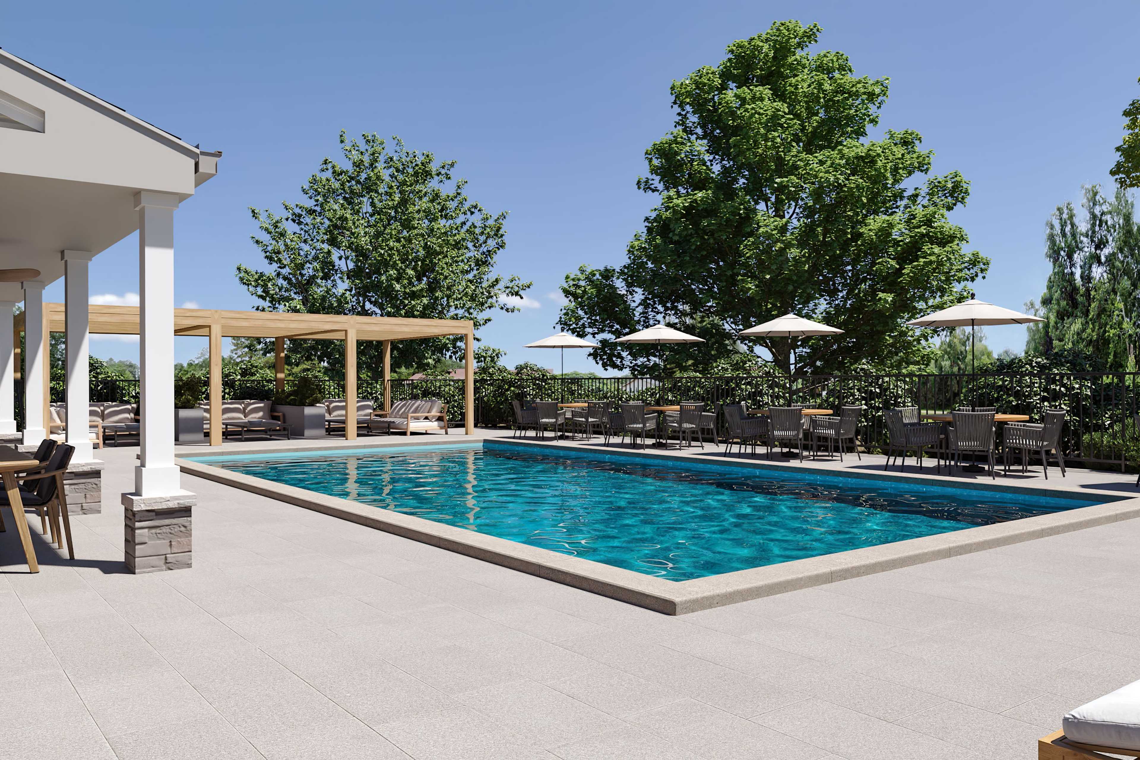 Resort-style pool at Kelly Preserve in Loganville Georgia with blue water lounge chairs umbrellas and covered pergola