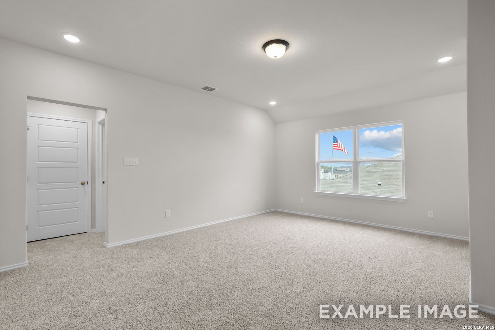 Spacious upstairs bedroom with plush carpet and large window in The Sequoia C floor plan at Royal Crest, San Antonio.
