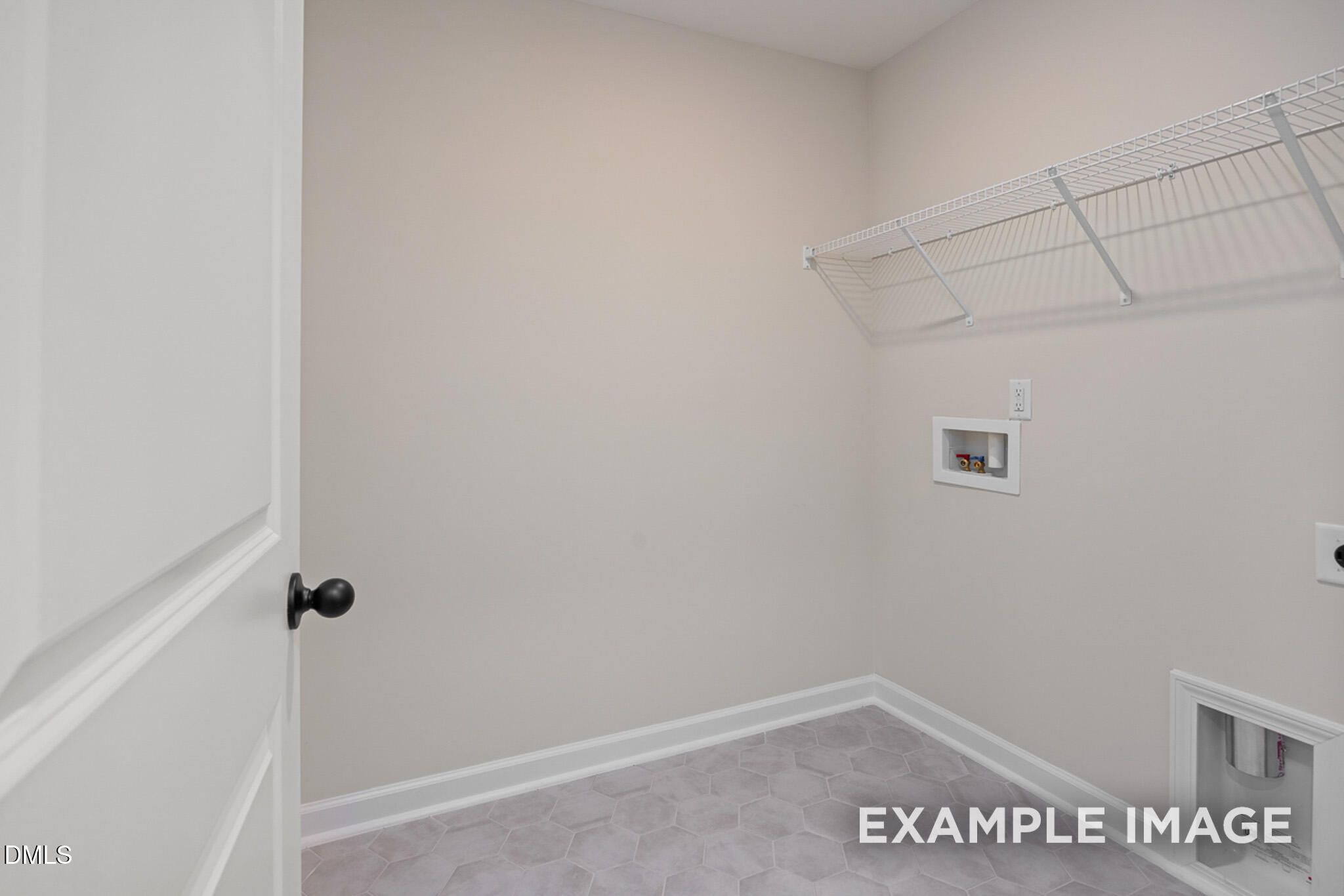 Laundry room with wire shelving and tile flooring in The Mitchell floor plan at Camden Park, Knightdale, North Carolina.