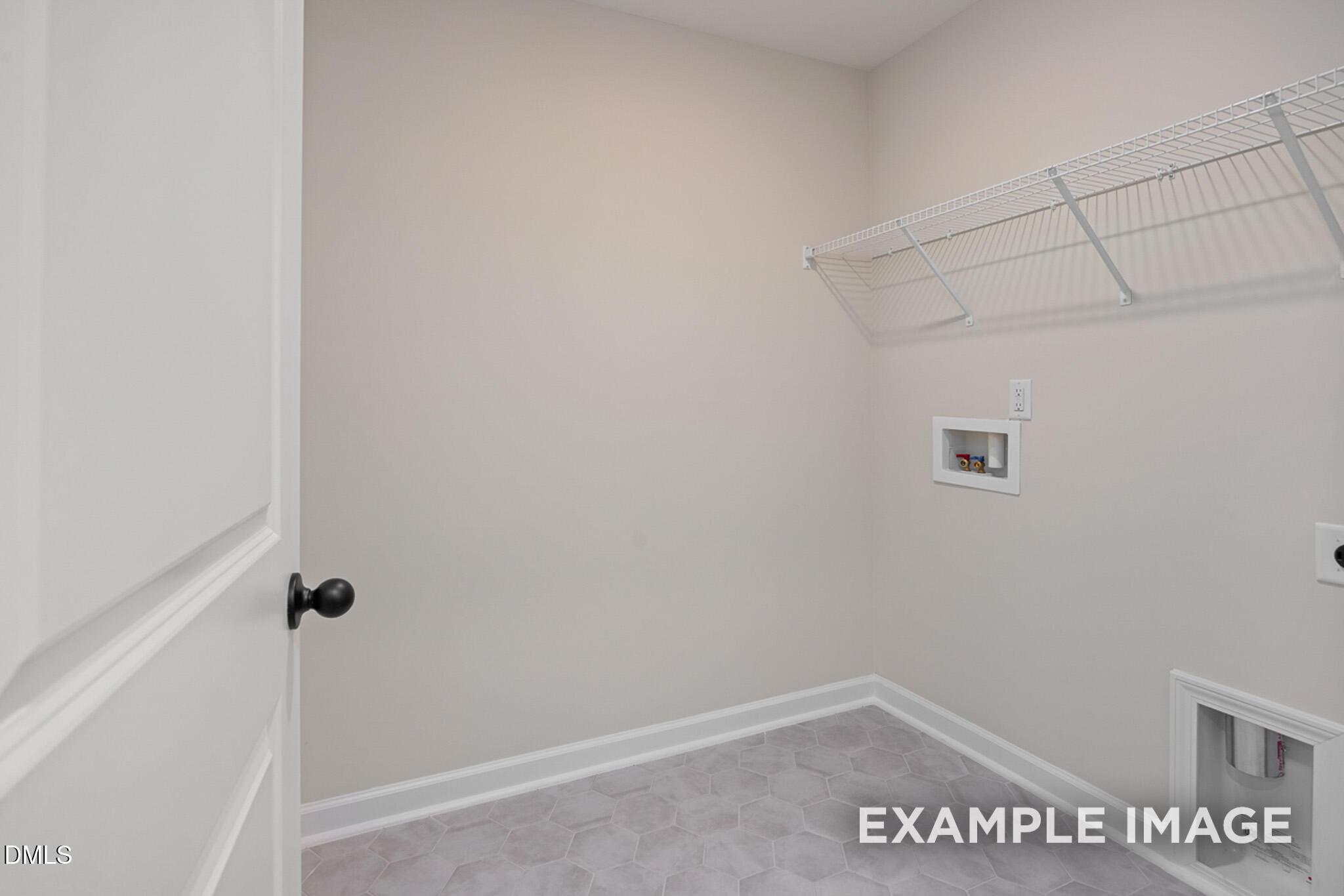 Laundry room with wire shelving and tile flooring in The Mitchell floor plan at Camden Park, Knightdale, North Carolina.