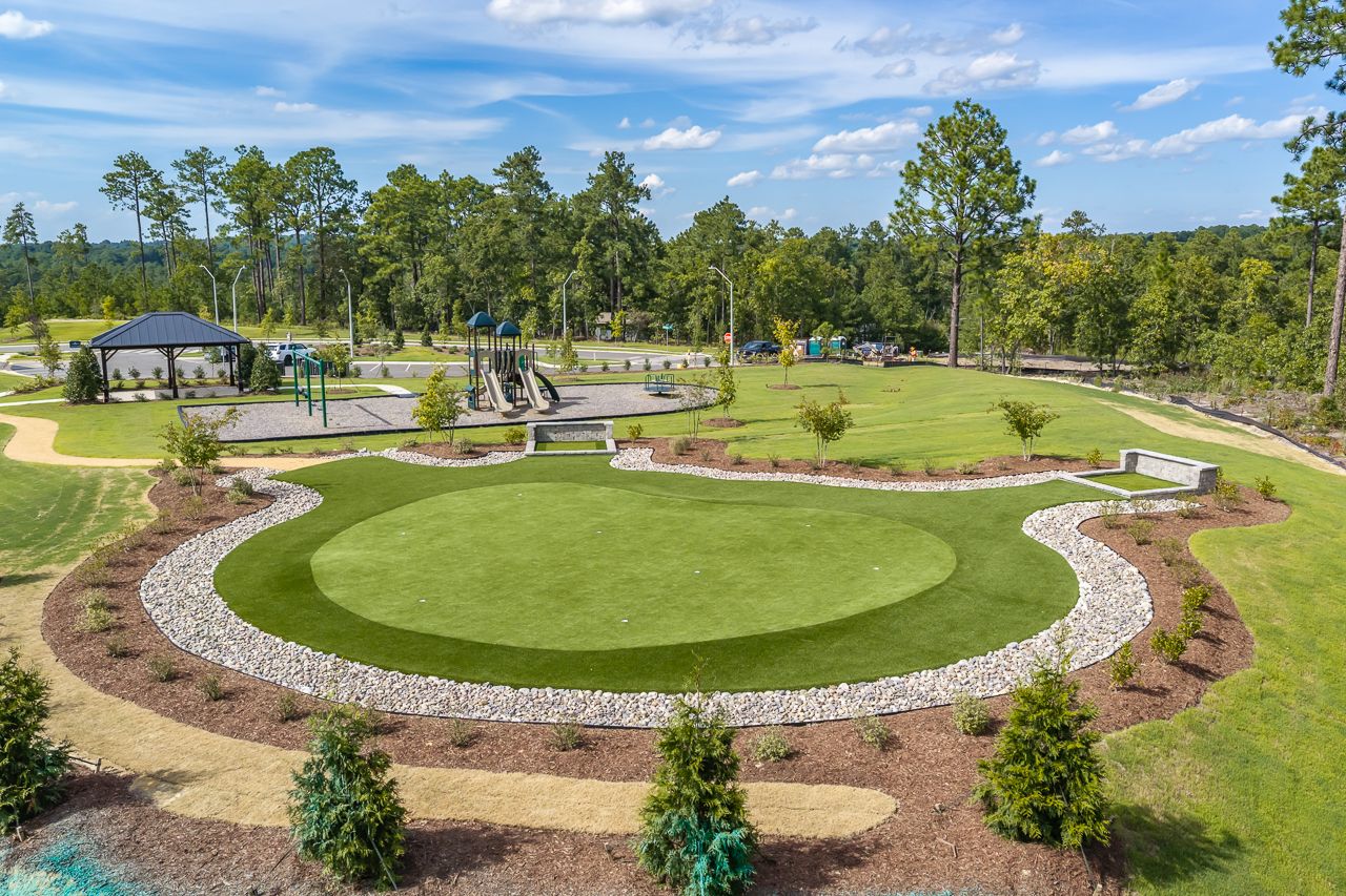 Putting green and community playground with pavilion at Montrose in Aberdeen, North Carolina by Davidson Homes