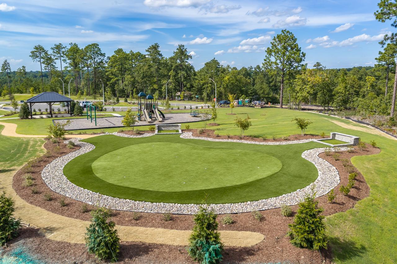 Putting green and community playground with pavilion at Montrose in Aberdeen, North Carolina by Davidson Homes
