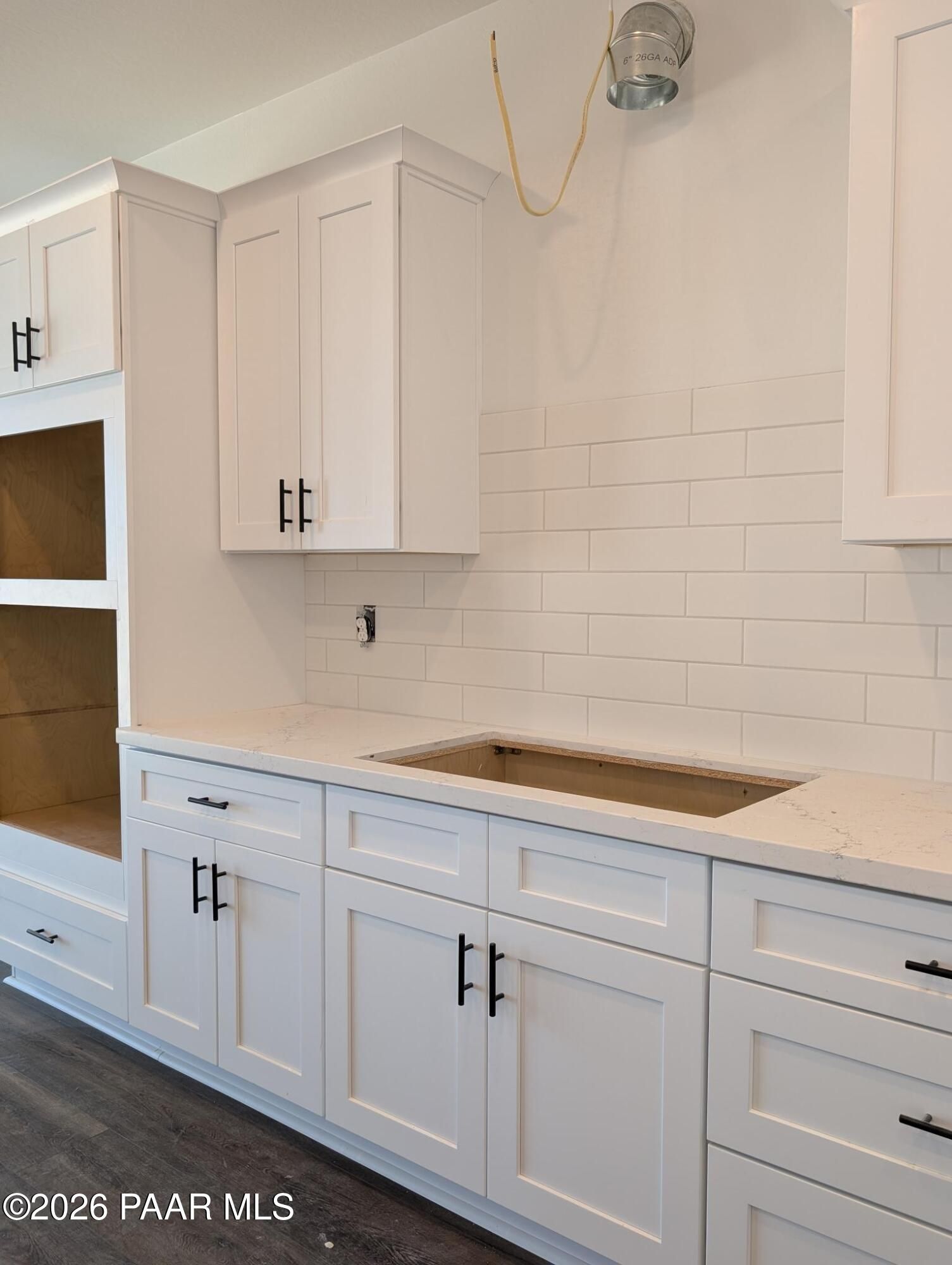 White kitchen cabinetry with subway tile backsplash in The Durango II G floor plan at South Ranch, Prescott, Arizona.