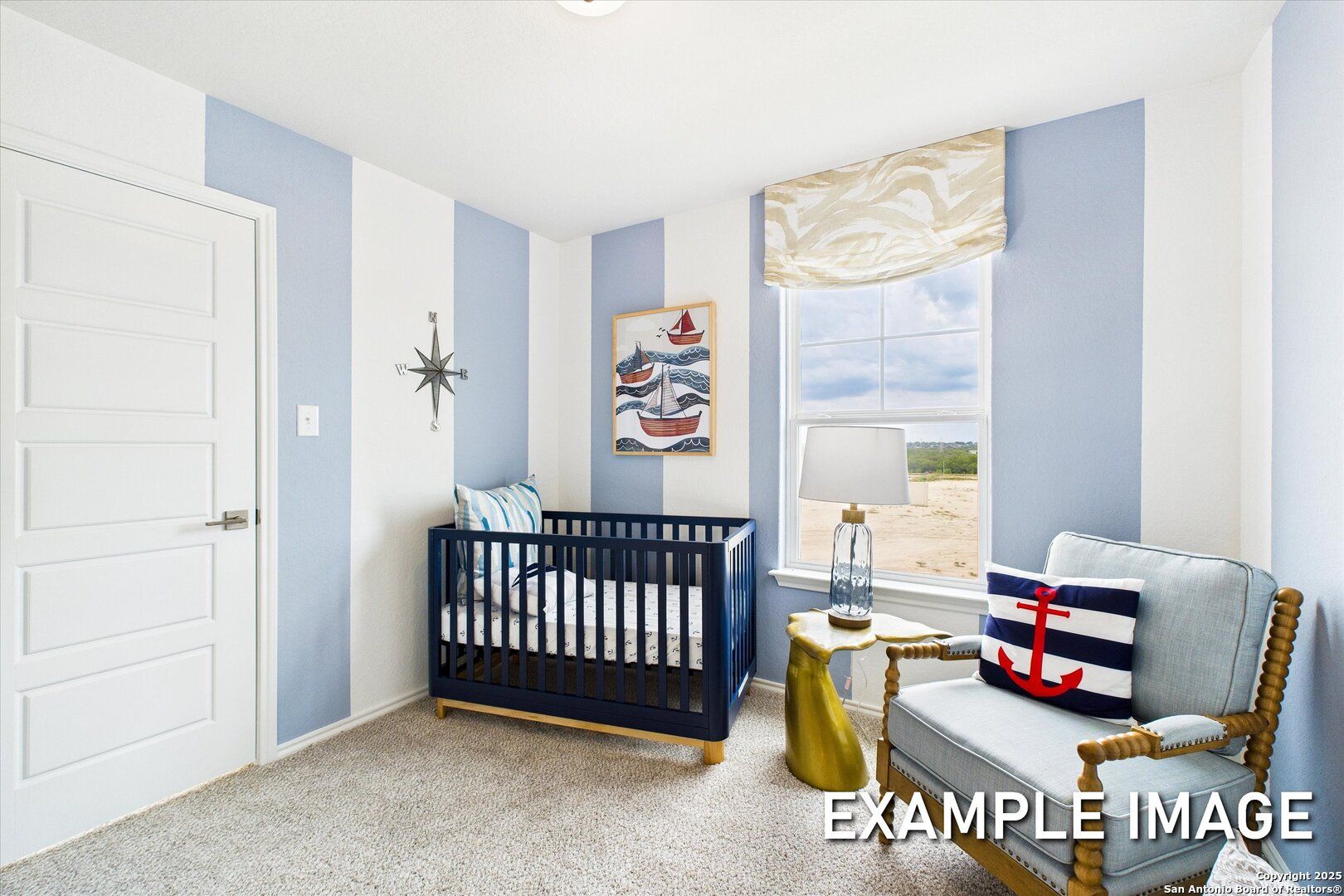 Nautical nursery with blue striped walls, crib, armchair, anchor pillow in 5-bedroom Davidson Homes The Brazos C, Agave, San Antonio