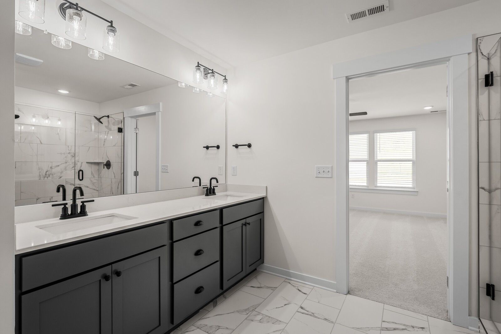 Modern master bathroom with dual vanity and walk-in shower in The Willow floor plan at Woods Crossing in Gallatin, TN.