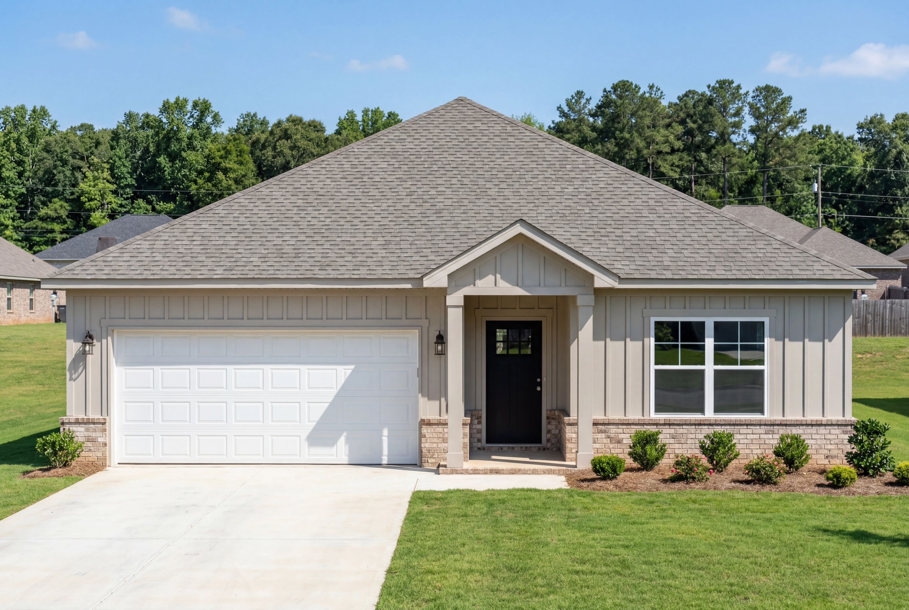 Front exterior of the single-story Daphne E home design by Davidson Homes featuring a two-car garage and brick accents.