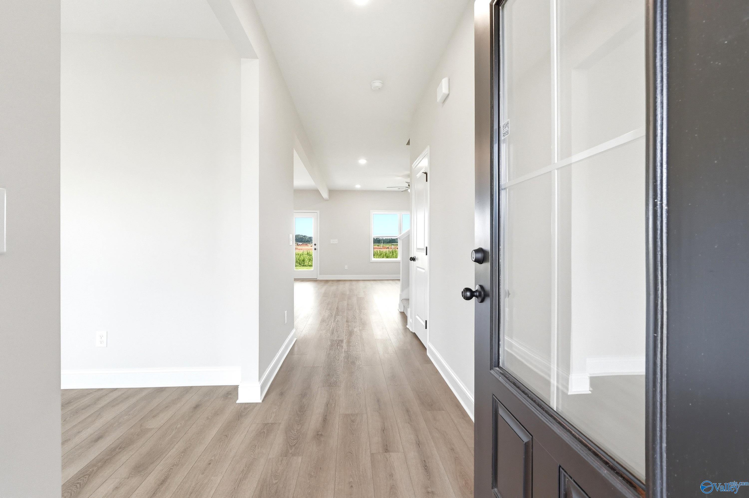 Bright entryway with light wood-style flooring leading into the Shelby A floor plan home in Clearview, Hazel Green, AL.