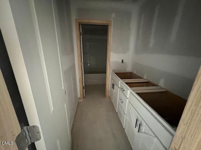 Unfinished bathroom with double vanity and tub-shower combo in The Hickory II C at Retreat at North Main, Lillington, NC.
