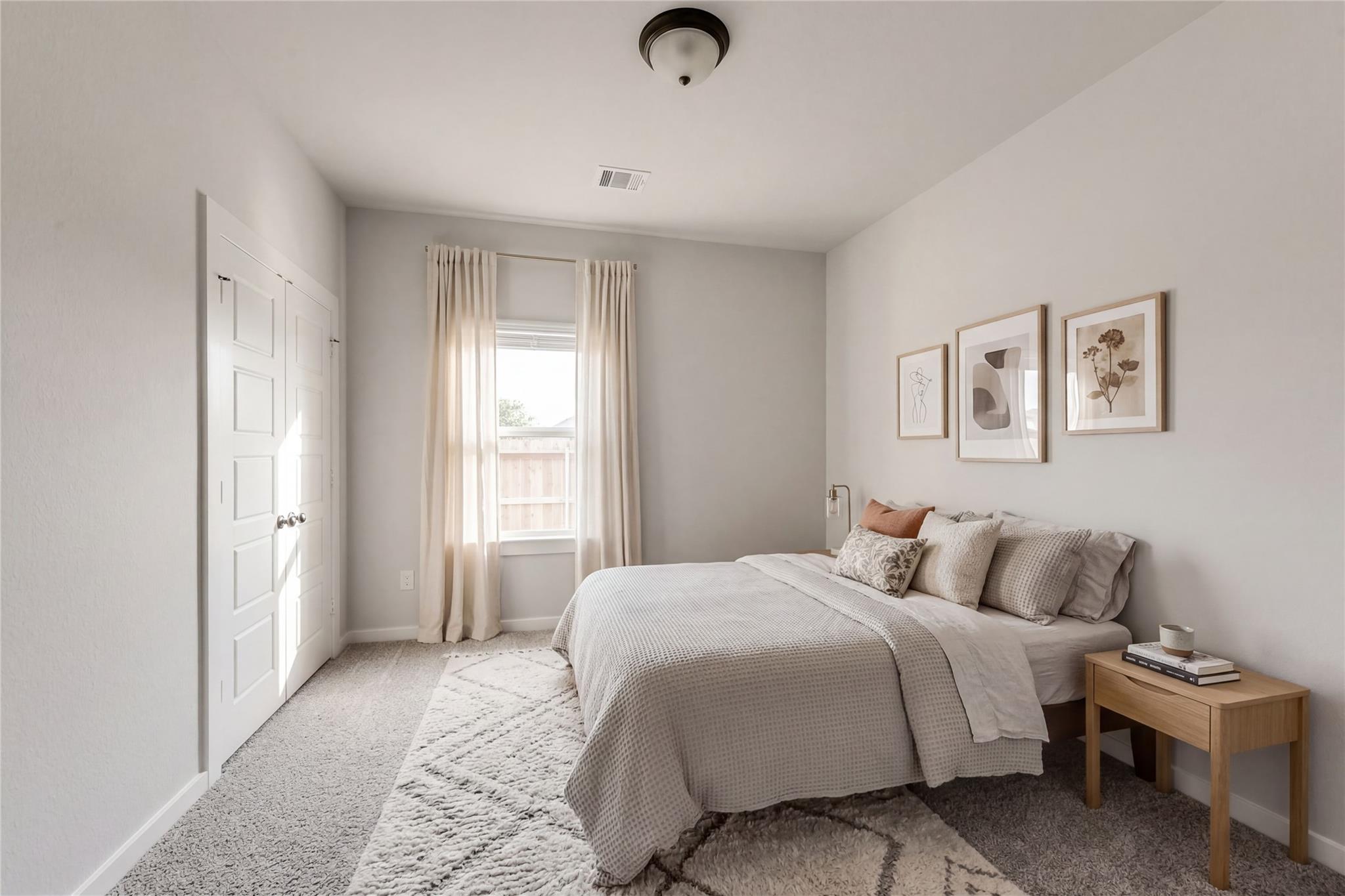 Serene neutral bedroom with gray bedding, sheer curtains, abstract wall art, double closet doors, and wooden nightstand in Davidson Homes Everett C, Crosby, Texas