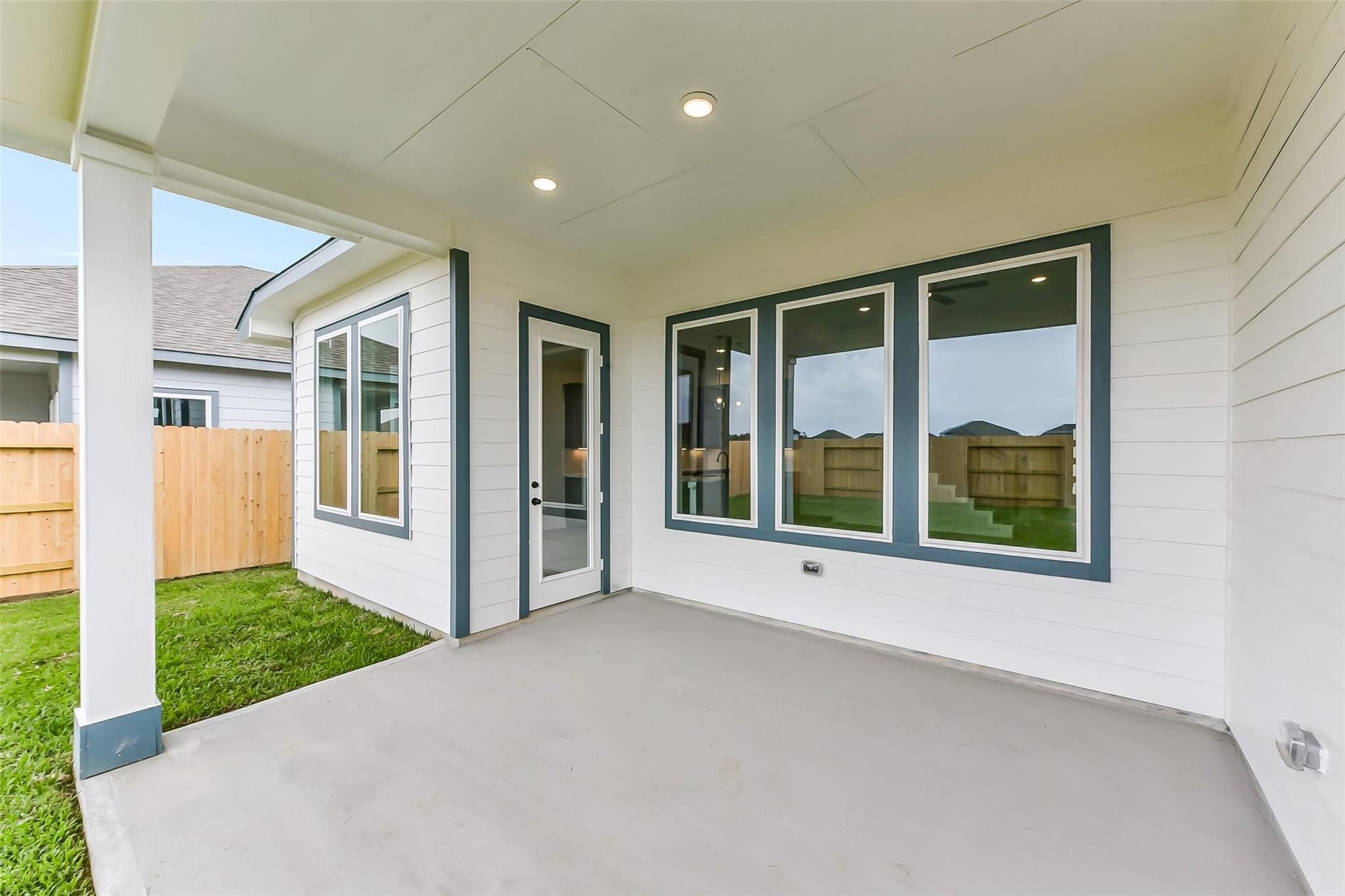Covered back patio with French doors and large windows in Davidson Homes Sequoia C, Sundance Cove, Crosby, Texas