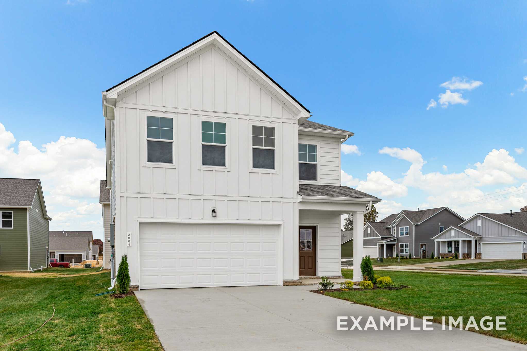 Two-story Grayson A home exterior with white board-and-batten siding, gabled roof, two-car garage, and front porch in White House, TN
