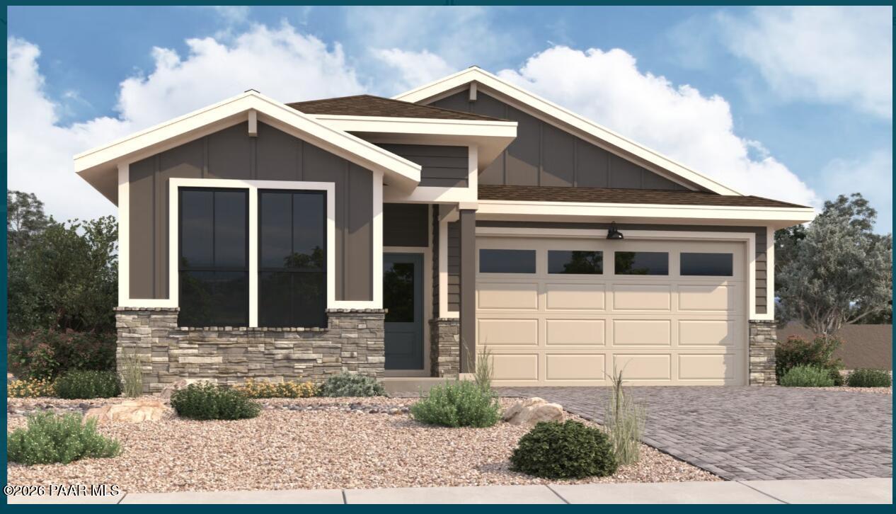 Modern gray-sided single-story home with stone accents, large windows, beige 2-car garage, and desert landscaping in Prescott, AZ