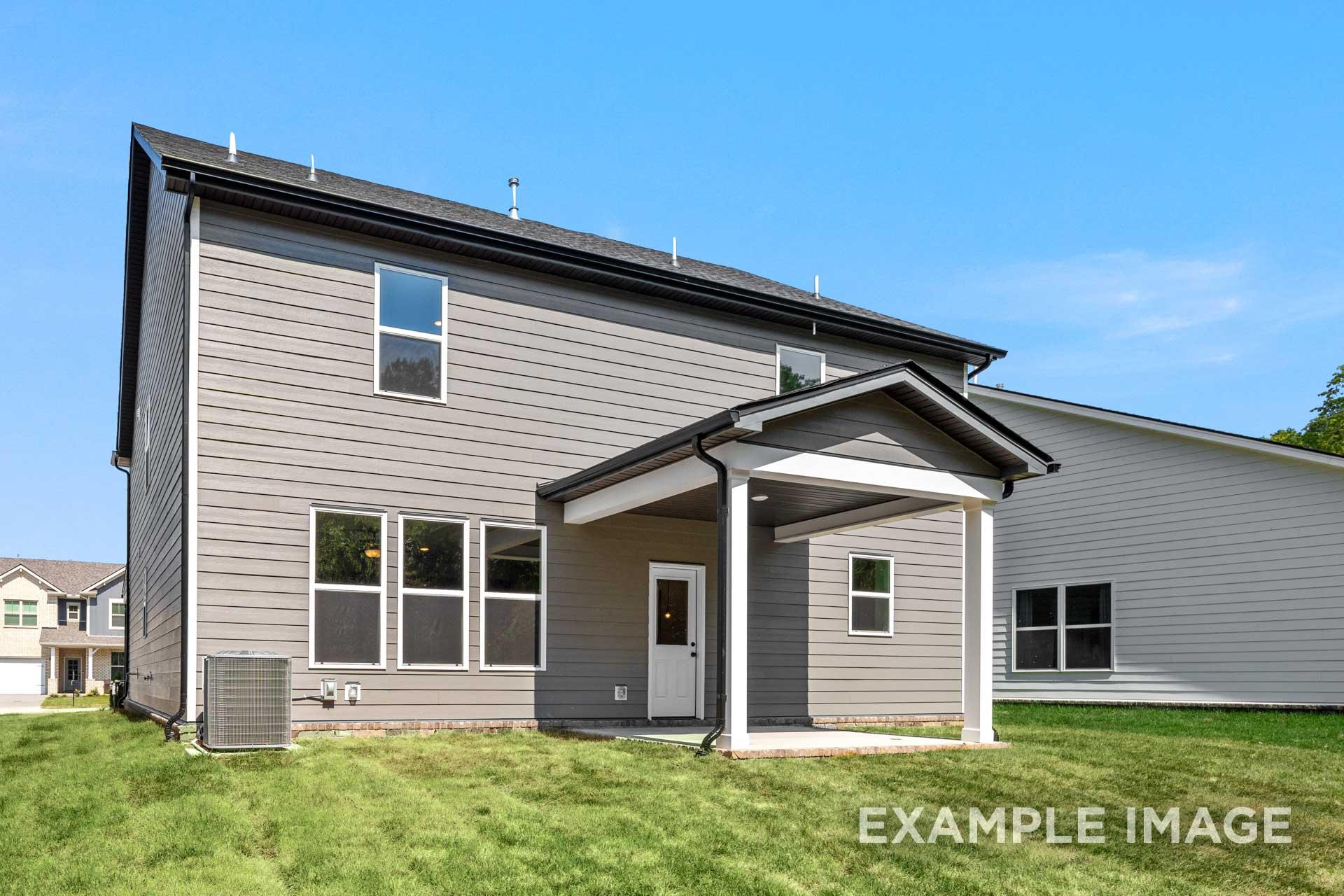 Rear elevation of The Henry B two-story home featuring gray siding, covered patio, and large windows in Mt. Juliet