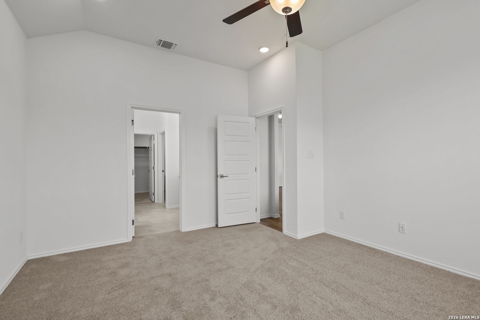Spacious secondary bedroom with white walls, ceiling fan, carpet floor, and adjacent bath in Davidson Homes The Sequoia B, San Antonio