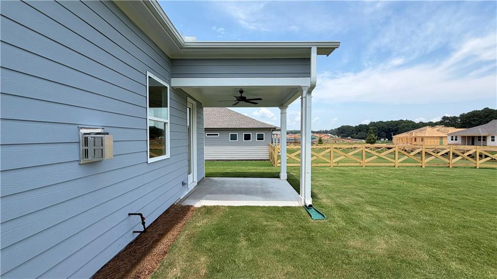 Covered back patio and spacious lawn at The Ash C floor plan by Davidson Homes in Wehunt Meadows, Hoschton, Georgia.