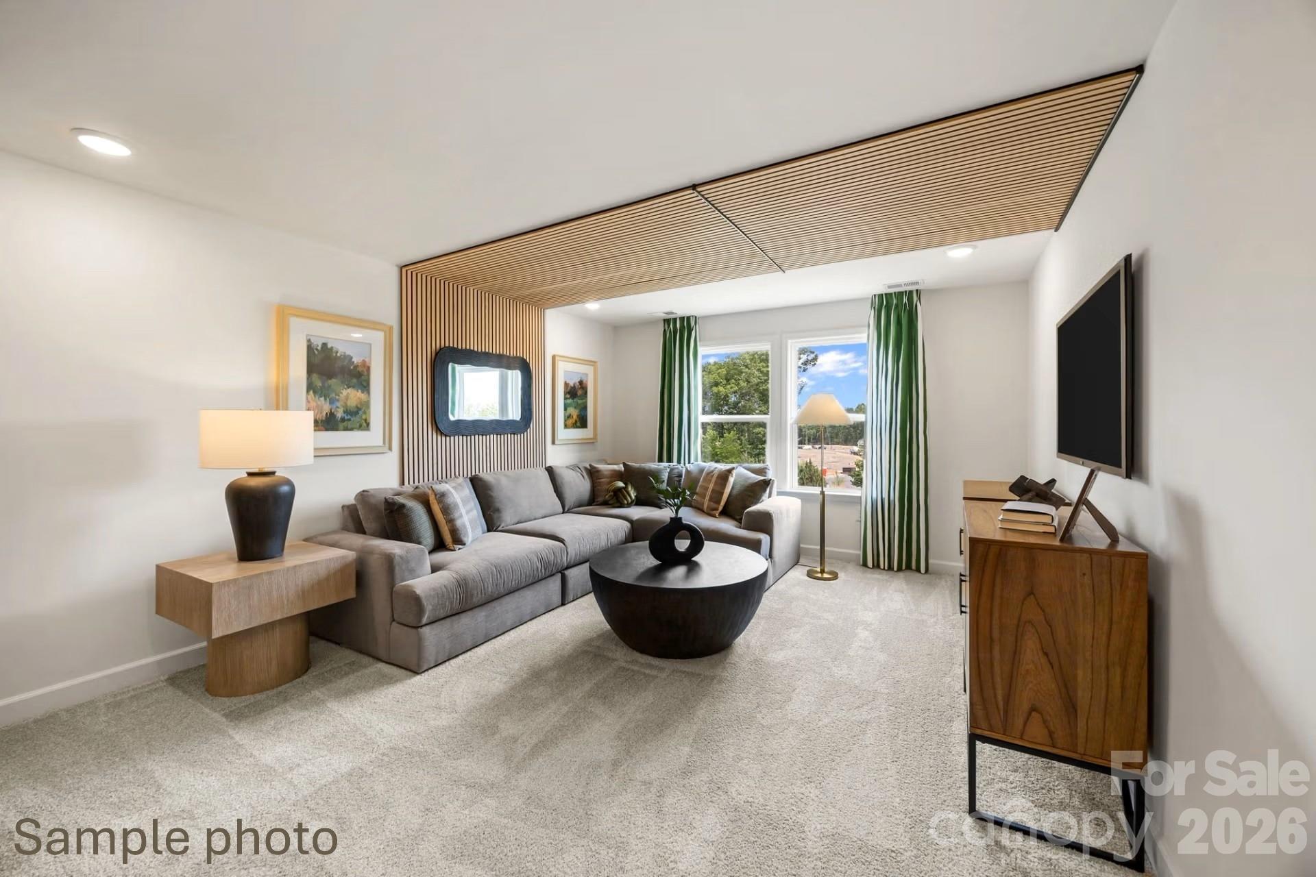 Modern living room with wood slat ceiling detail in The Beech B floor plan at Enclave at Belmont, North Carolina.
