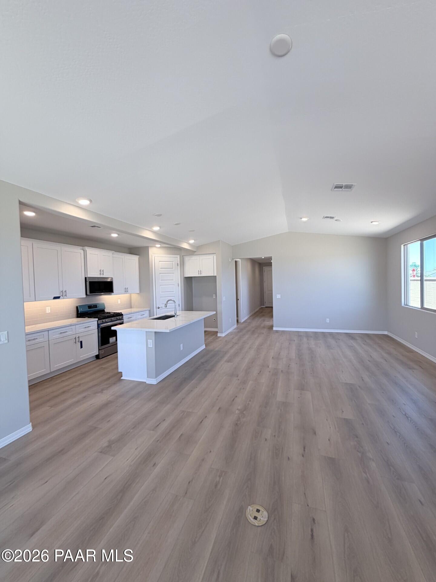 Open-concept kitchen and living area in The Frontier A floor plan at North Ridge, Pronghorn Ranch, Prescott Valley, AZ.
