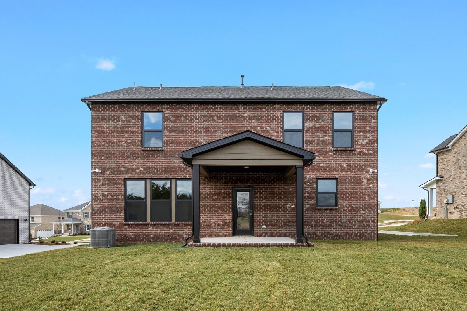 Back exterior view of The Henry C floor plan by Davidson Homes featuring a brick facade in Benders Cove, Mt. Juliet, TN.