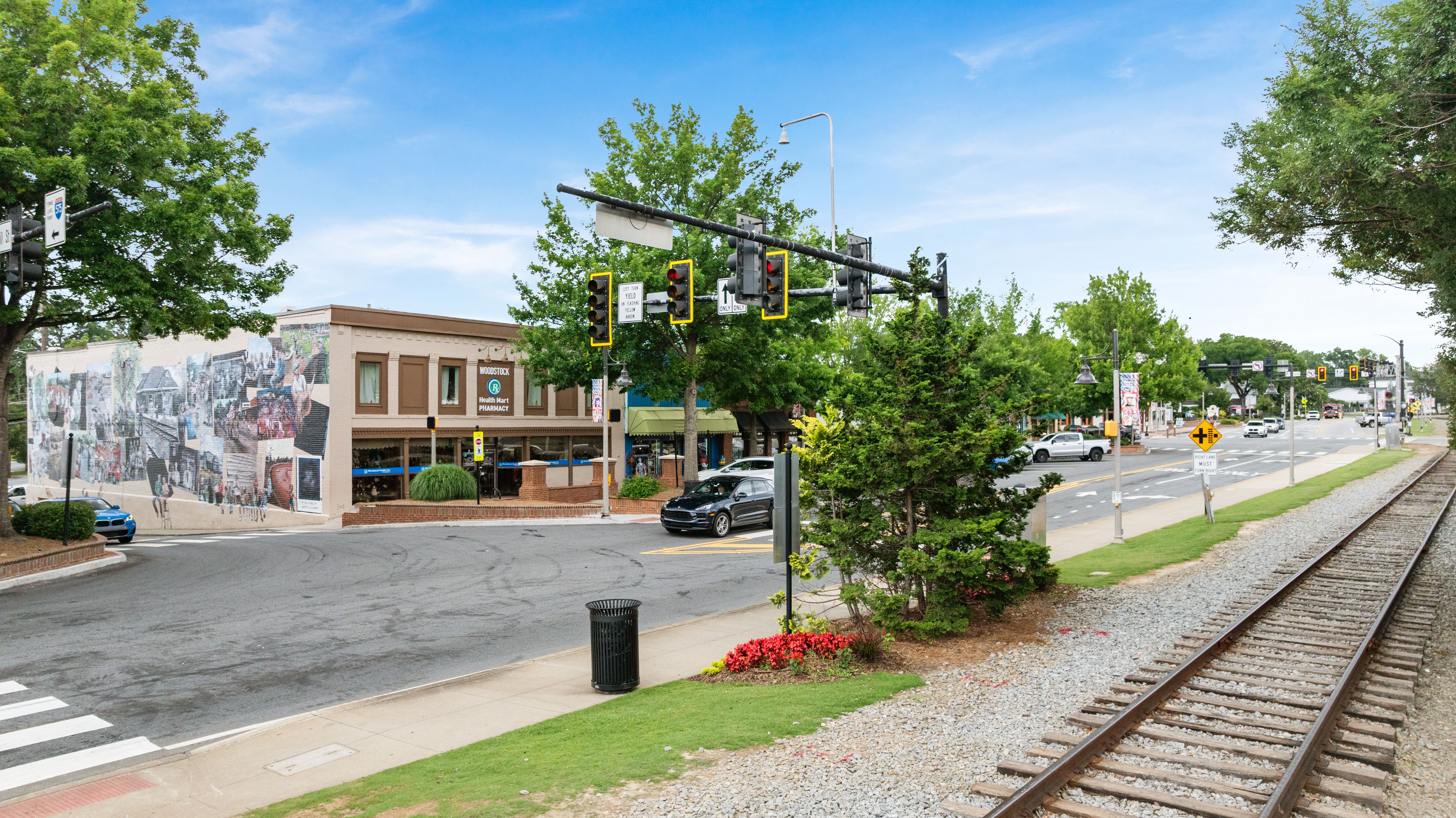 Historic downtown street view in Woodstock, Georgia near Grafton Trace by Davidson Homes with railroad tracks and storefronts.