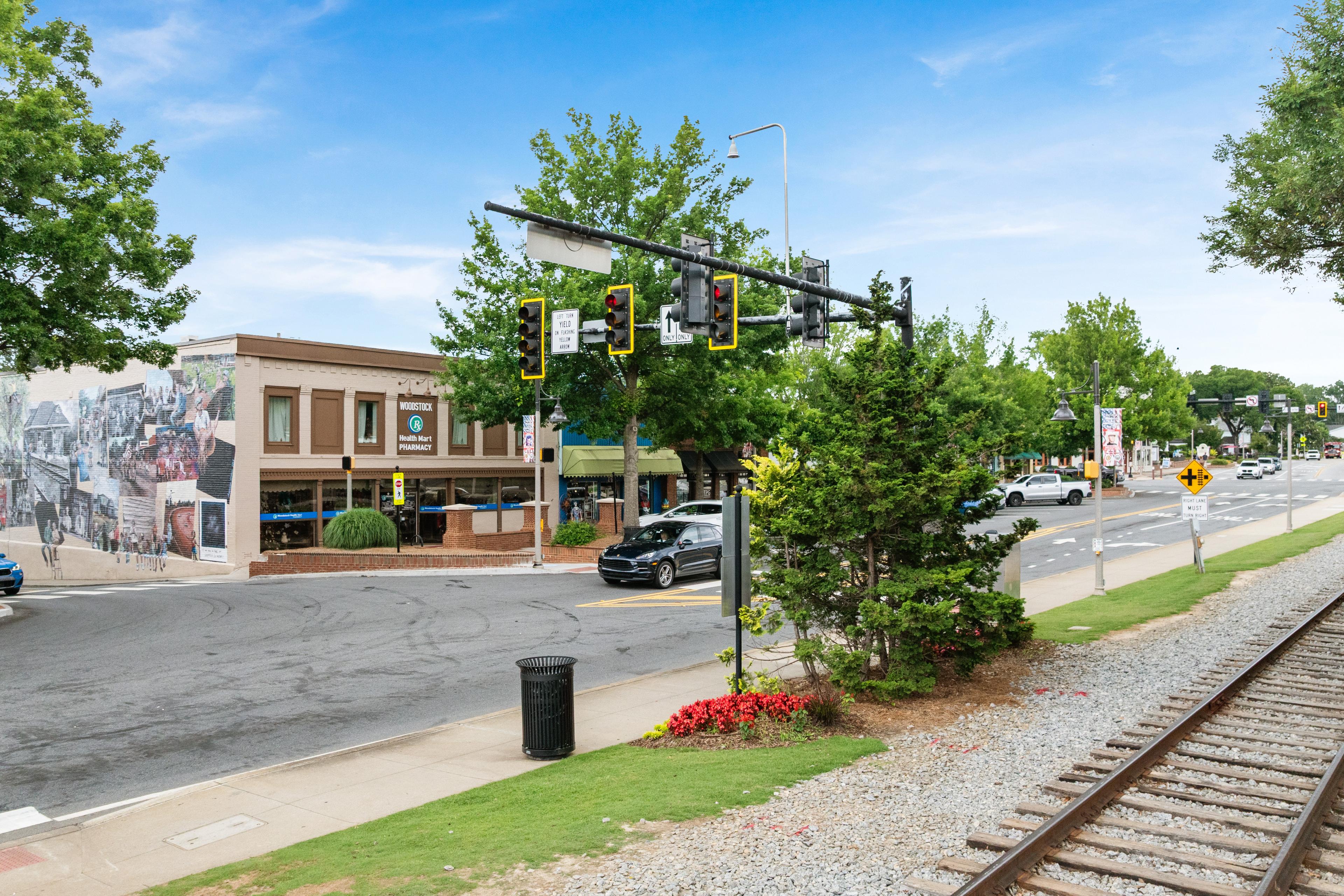 Historic downtown street view in Woodstock, Georgia near Grafton Trace by Davidson Homes with railroad tracks and storefronts.