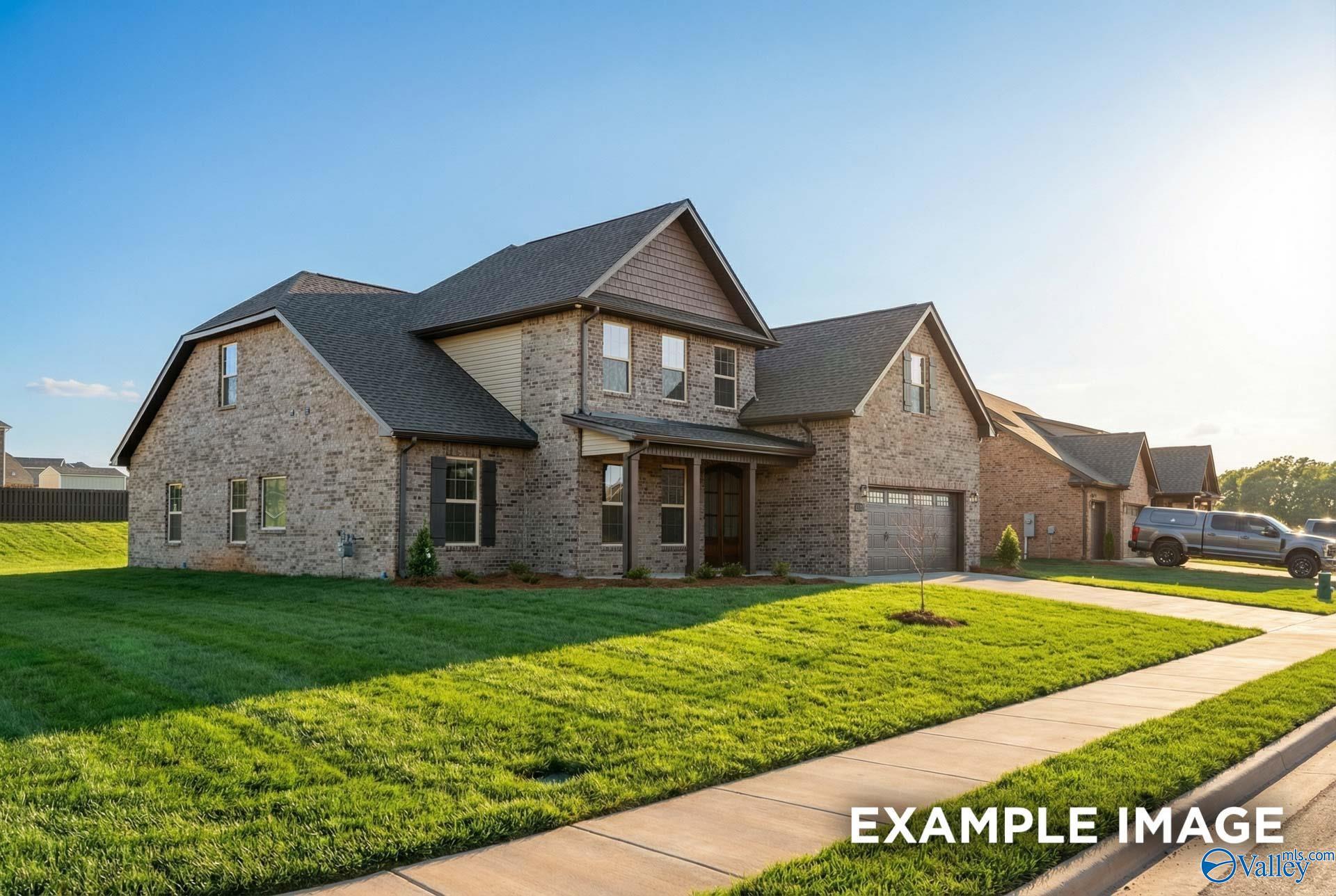 Two-story brick and siding home with 2-car garage, covered porch, and manicured lawn in Hollon Meadow, Decatur, Alabama - Davidson Homes The Emory