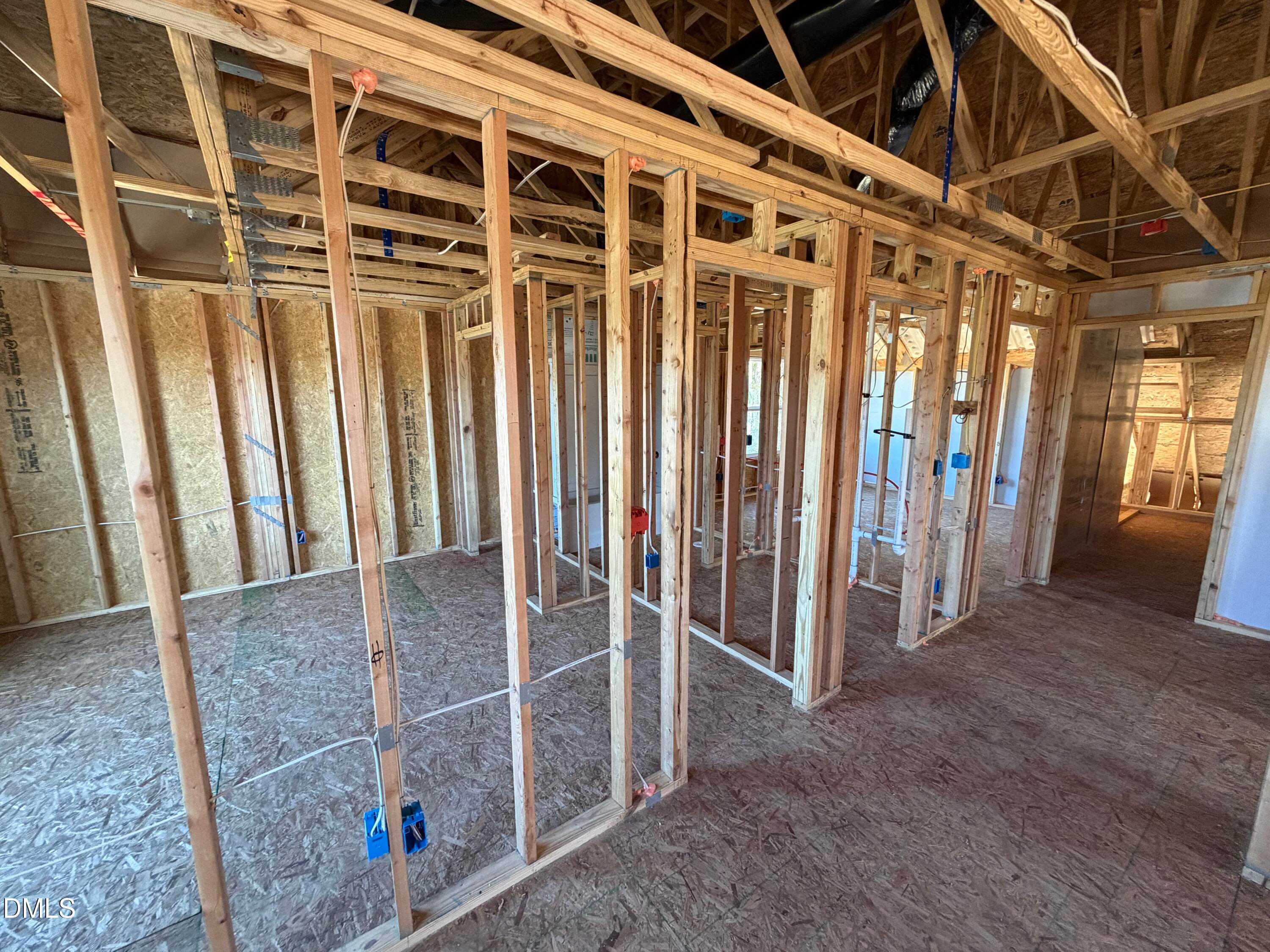 Wooden framed interior with exposed studs and open layout in The Ash B 3-bedroom new home, Wellers Knoll, Lillington, NC