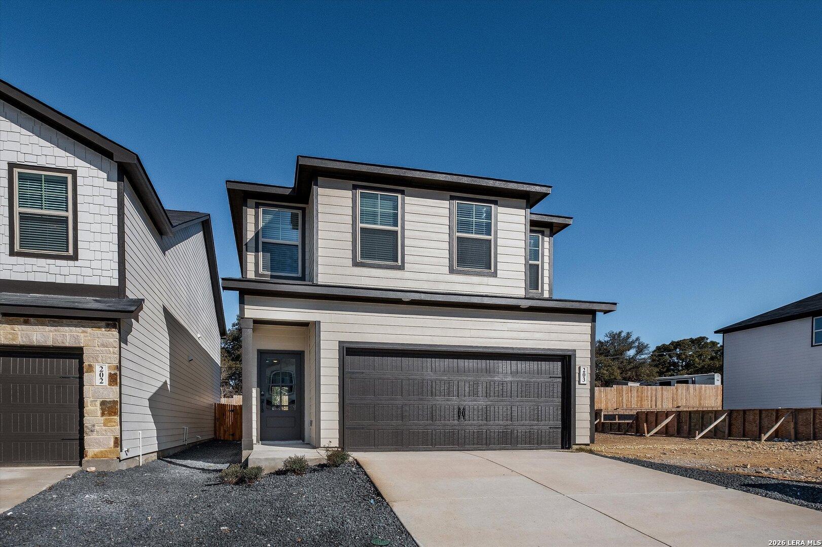 Two-story gray home with 2-car garage and driveway in Meadows at Oak Creek, San Antonio, Texas - Davidson Homes Charlotte A