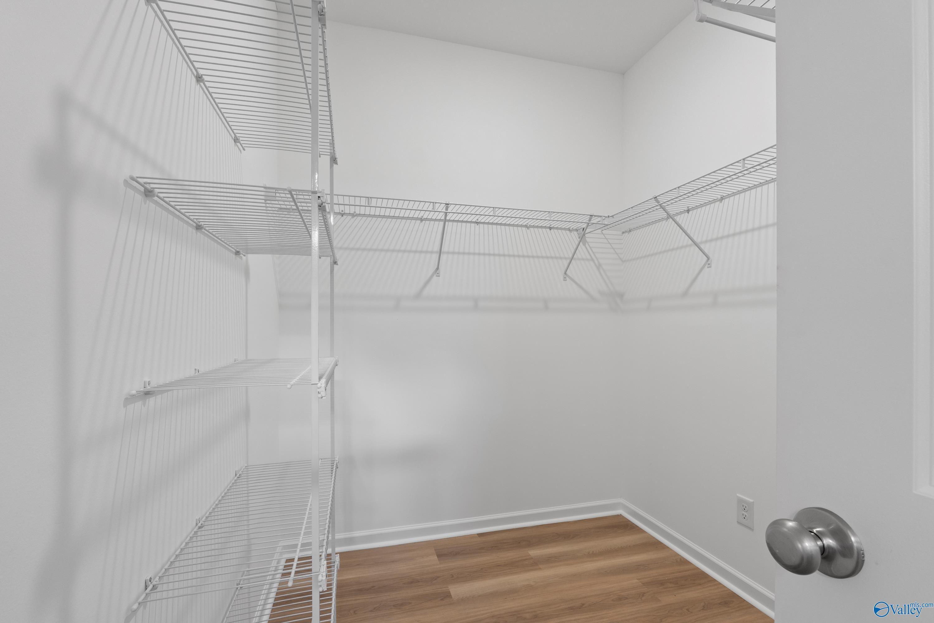 Spacious walk-in closet with wire shelving and hardwood floors in Davidson Homes The Polaris, Fayetteville, TN