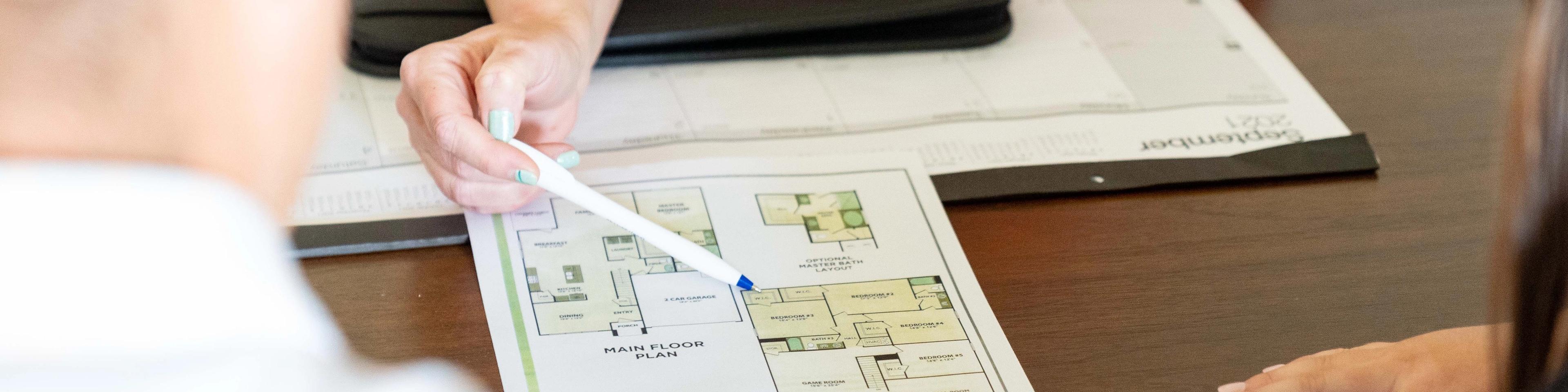 A realtor helps a young couple preparing to buy a home