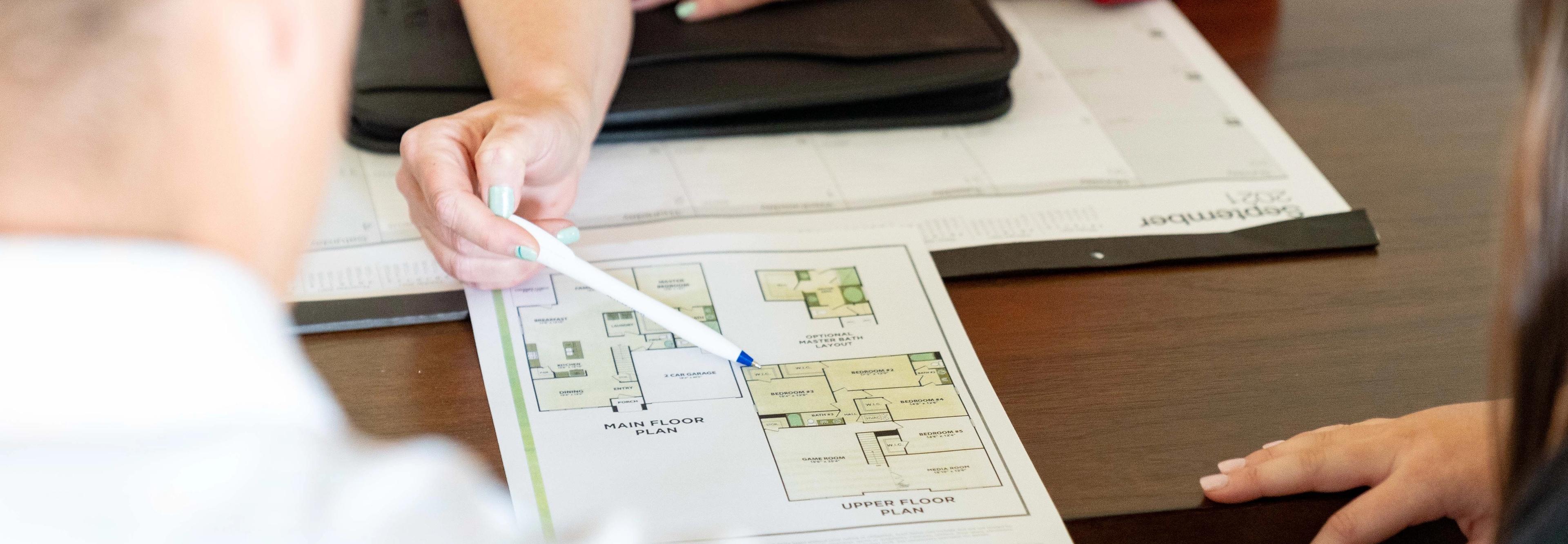 A realtor helps a young couple preparing to buy a home