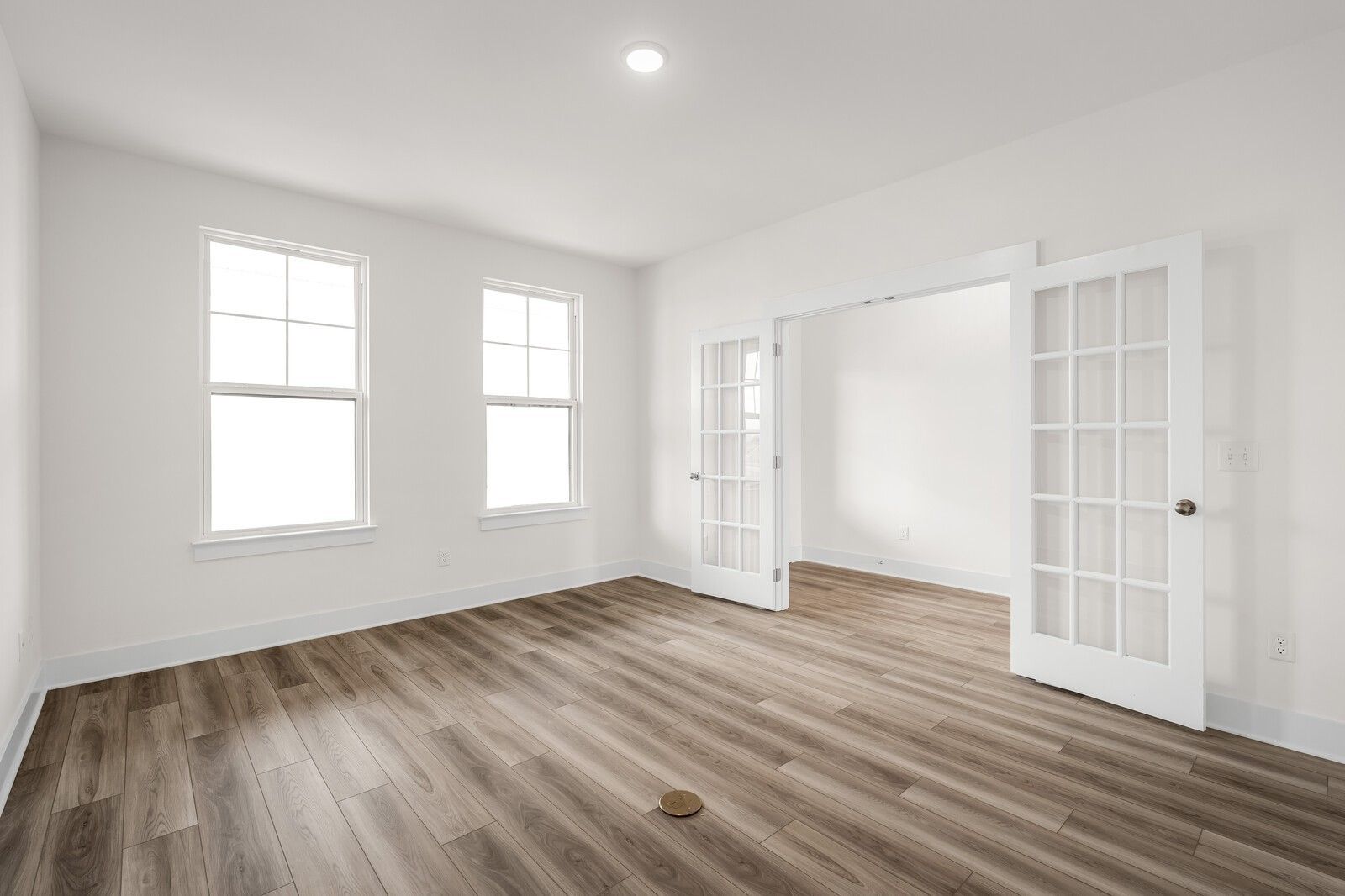Bright home office with French doors and wood-look flooring in The Henry C floor plan, Benders Cove, Mt. Juliet, Tennessee.