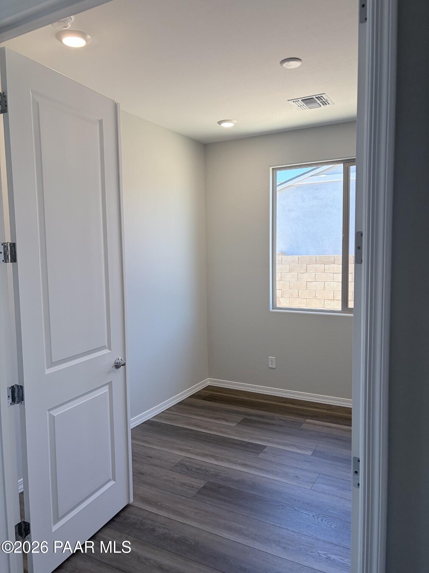 Bright bedroom with wood-look flooring and recessed lighting in The Frontier A floor plan at North Ridge, Prescott Valley.