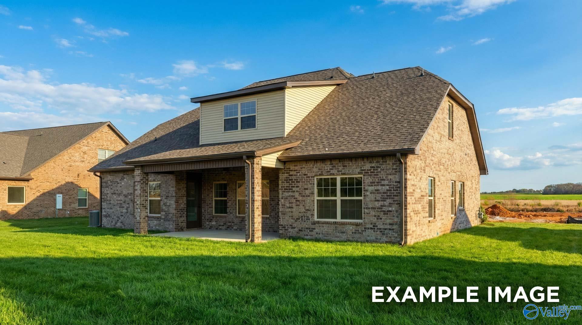 Two-story brick home with covered front porch, garage, and green lawn in Hollon Meadow, Decatur, Alabama - Davidson Homes The Emory