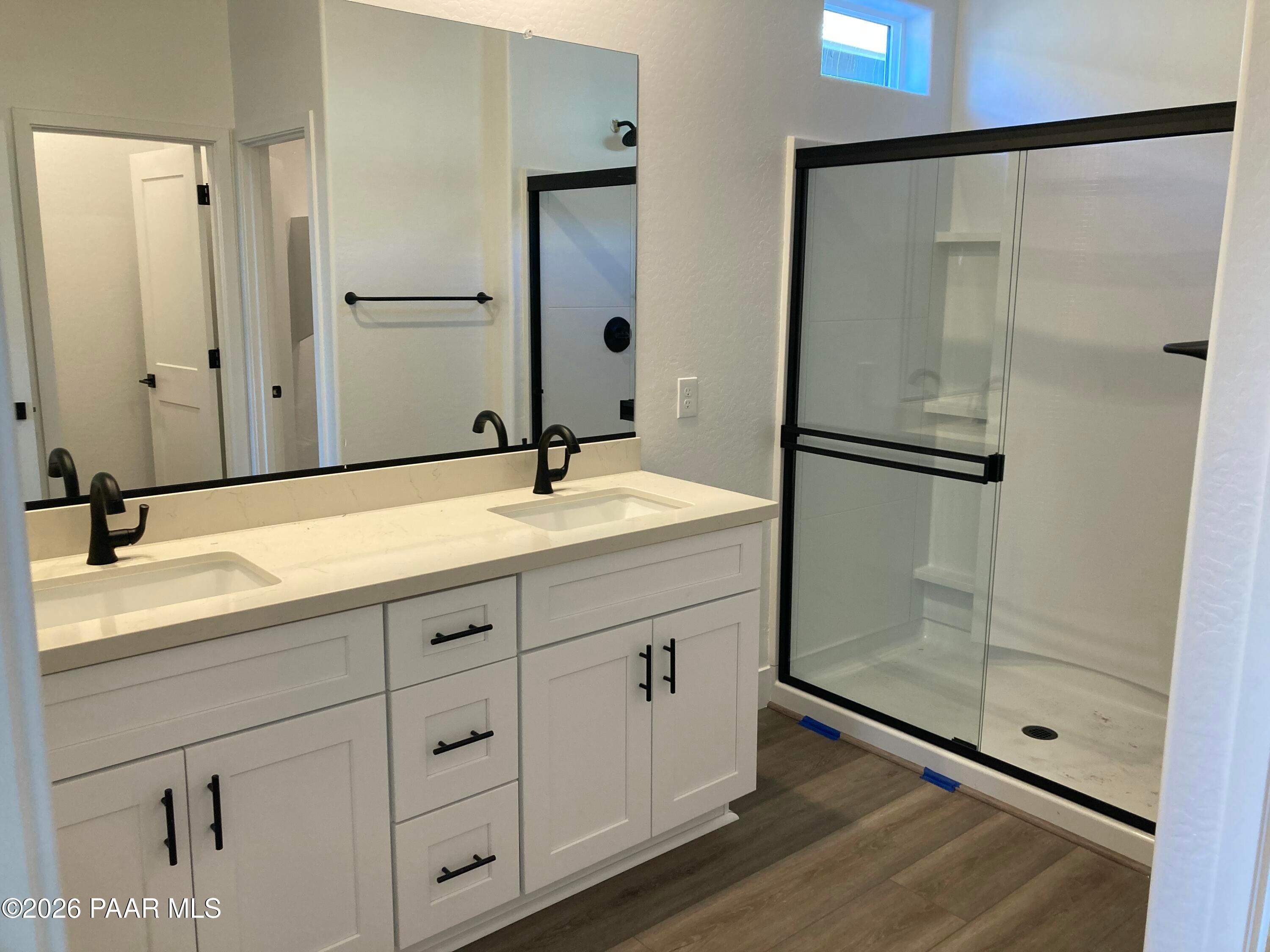 Modern master bathroom featuring double vanity, quartz counters, and frameless glass shower in Davidson Homes The Malibu C, Prescott, AZ