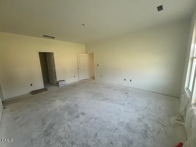 Spacious empty primary bedroom with natural light and walk-in closet access in Davidson Homes Magnolia II B plan, Lillington NC
