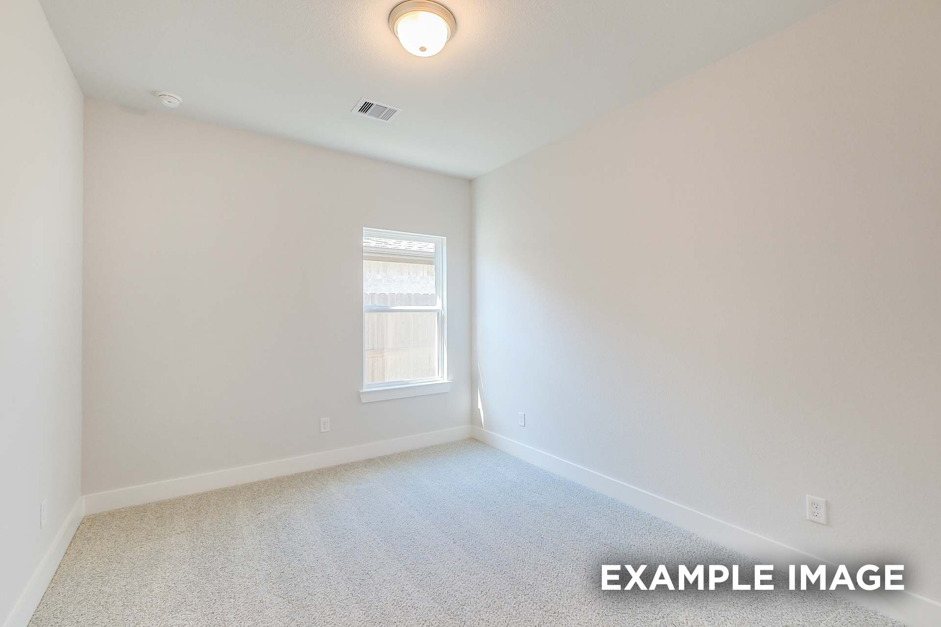 Spacious secondary bedroom in The Luna K floor plan by Davidson Homes, Katy Texas: beige carpet, neutral walls, large window with blinds