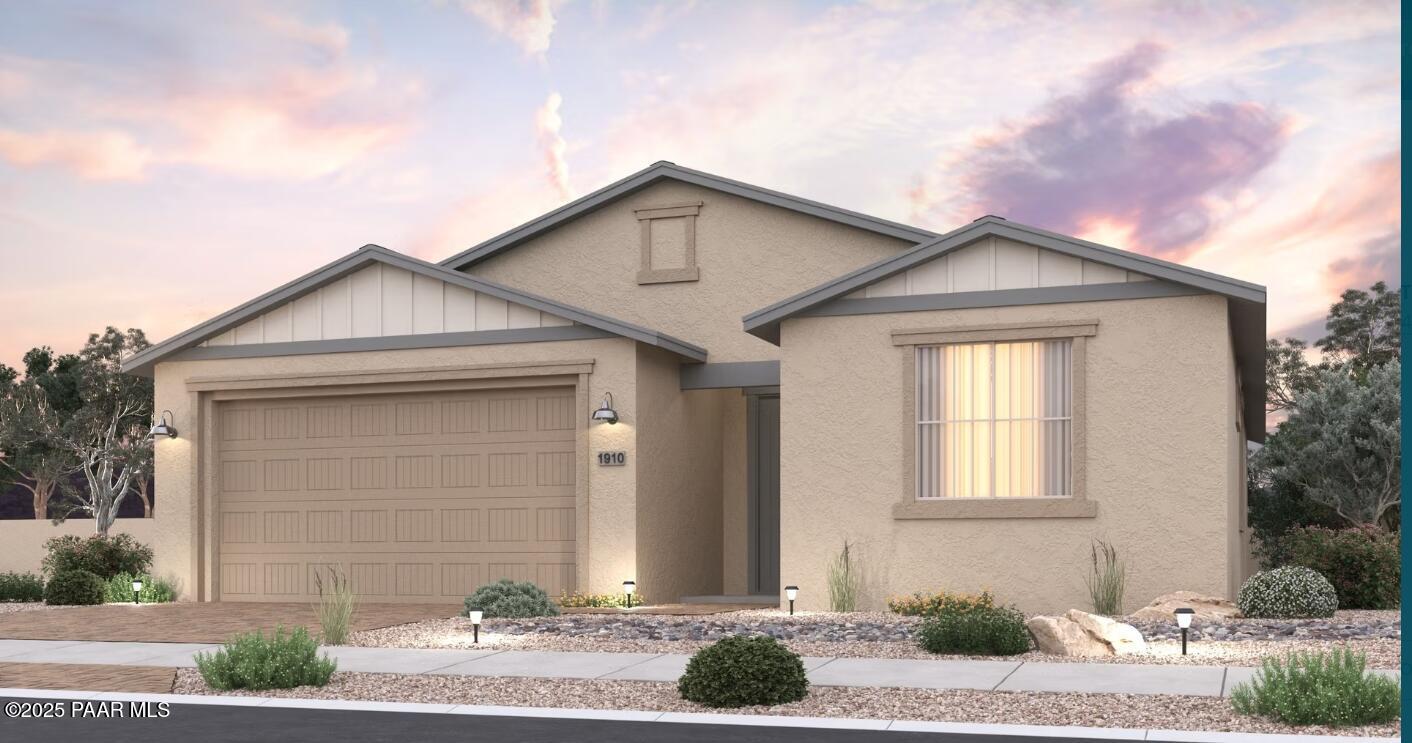 Modern beige single-story home with 2-car garage, gabled roof, and desert landscaping at sunset in Prescott Valley, Arizona - Davidson Homes Inspiration B