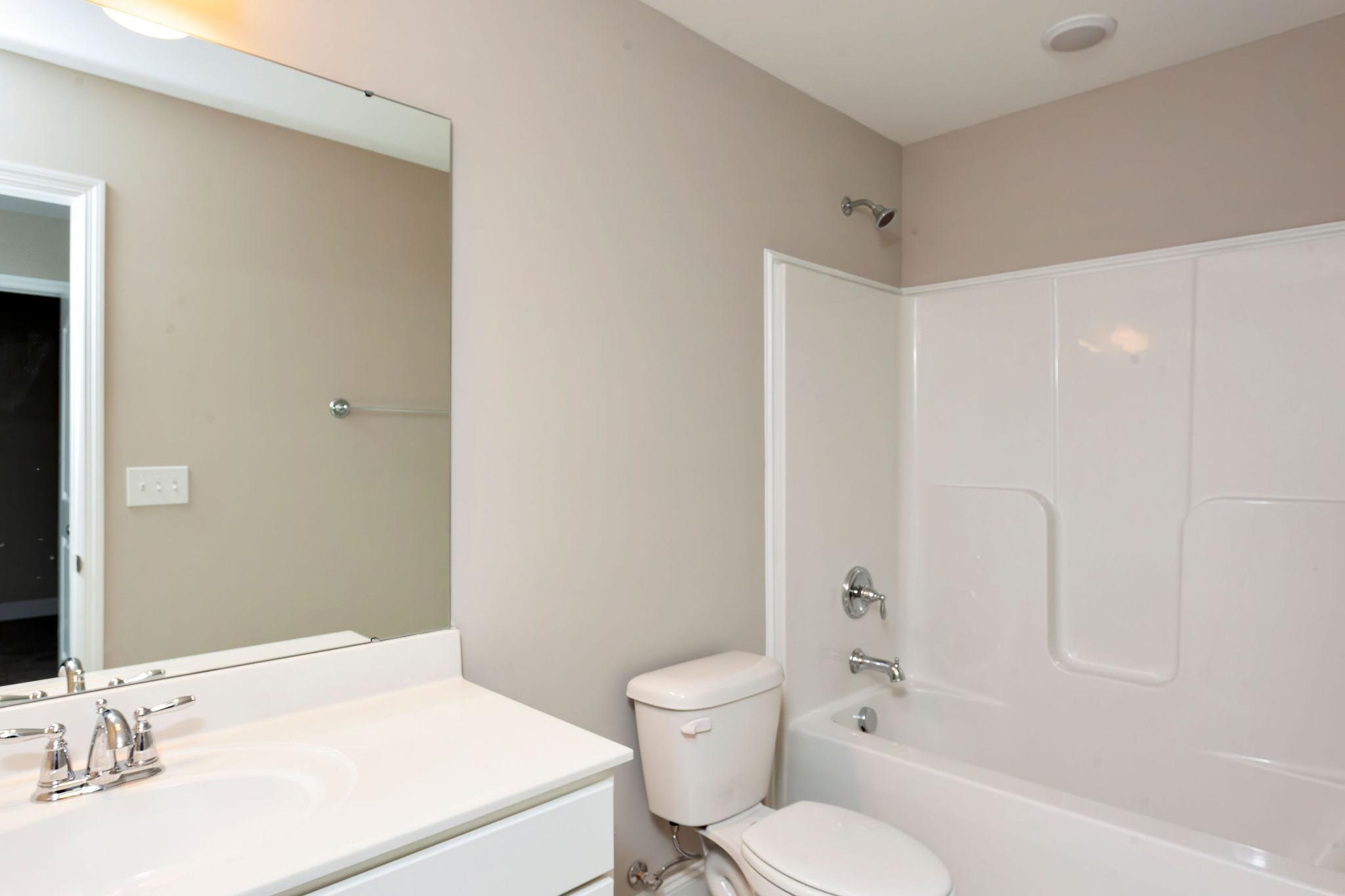 Davidson Homes The Emory Floor Plan Bathroom with single vanity, toilet, and shower