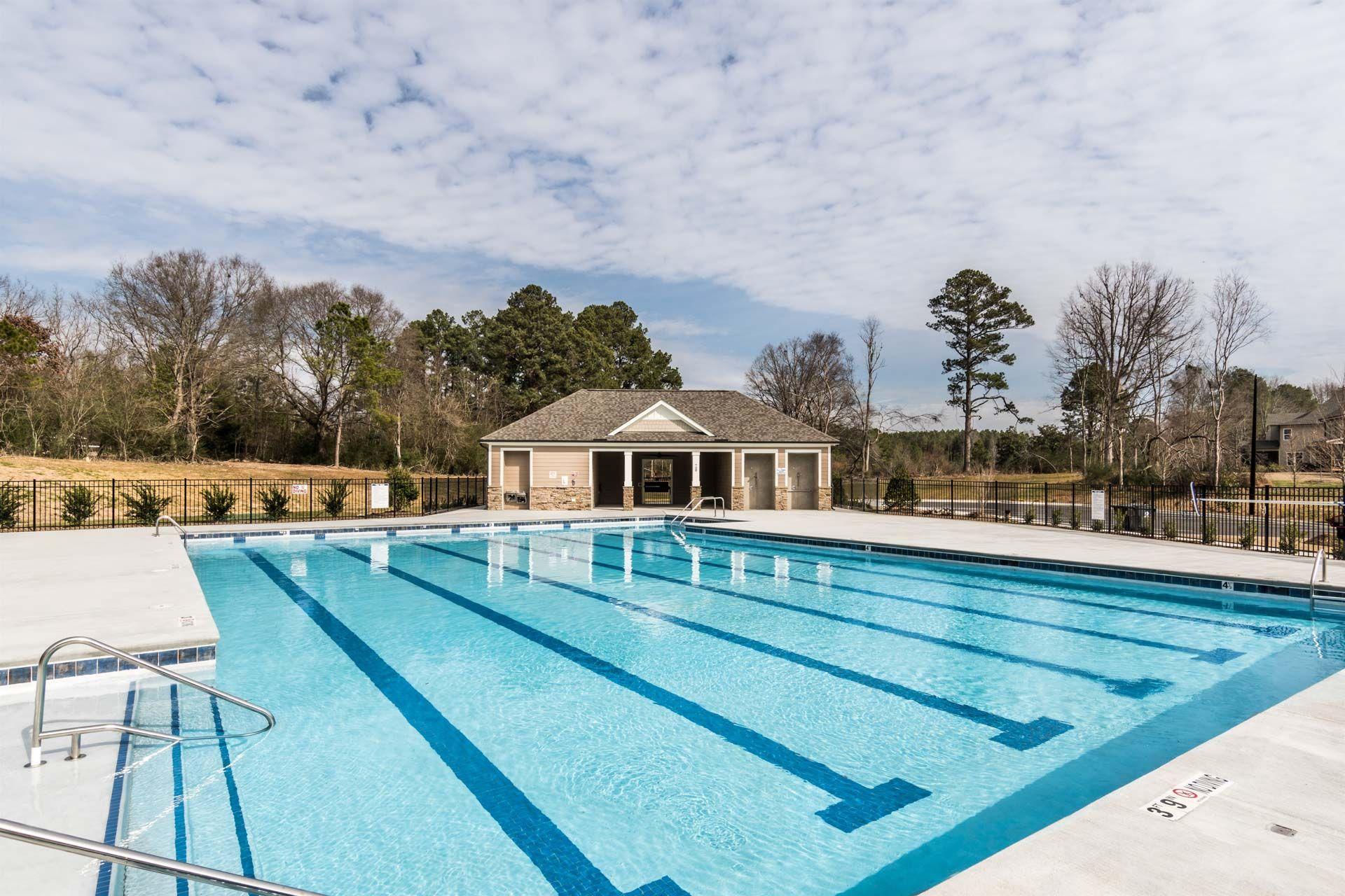Community swimming pool at Camden Park in Knightdale NC with lap lanes, sundeck, and pavilion clubhouse