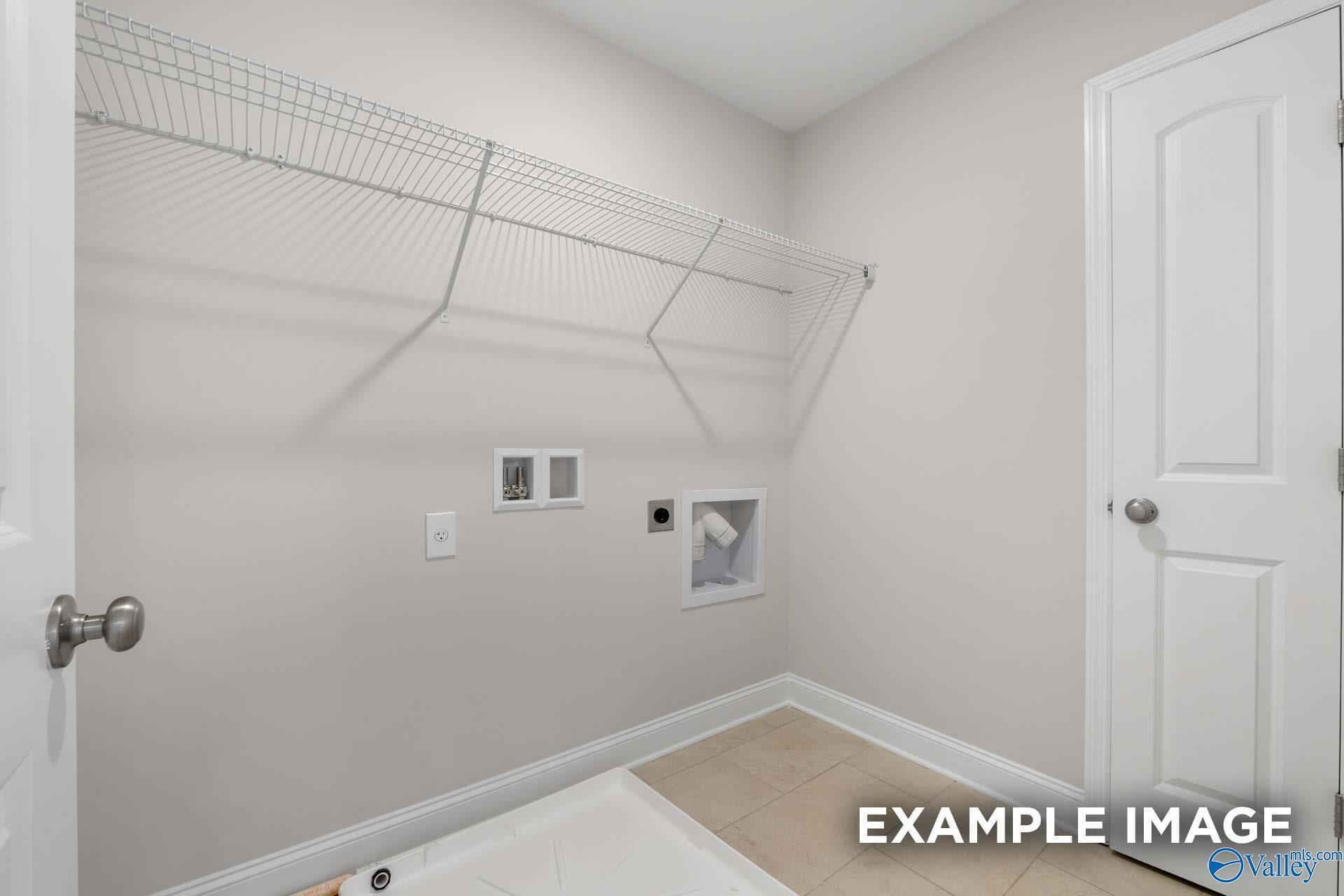 Spacious laundry room with wire shelving, washer dryer hookups in Davidson Homes The Madison A, Toney, Alabama