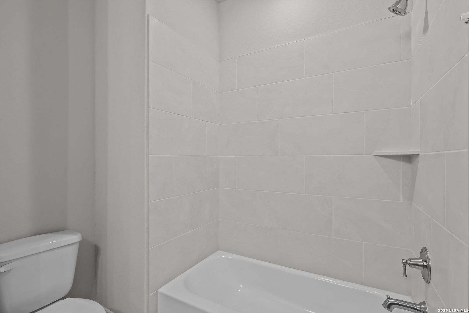 Modern white-tiled shower and corner soaking tub in master bathroom, Davidson Homes The Rockford G, Ladera, San Antonio