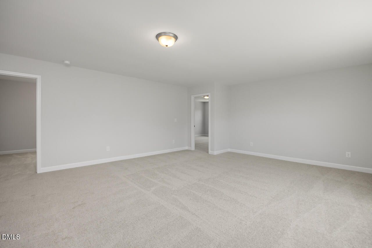 Spacious neutral-toned bedroom in The Adalynn A floor plan at Gregory Village, Lillington, North Carolina.