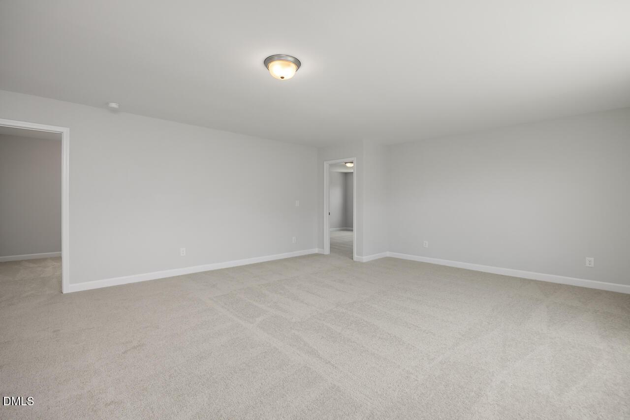 Spacious neutral-toned bedroom in The Adalynn A floor plan at Gregory Village, Lillington, North Carolina.