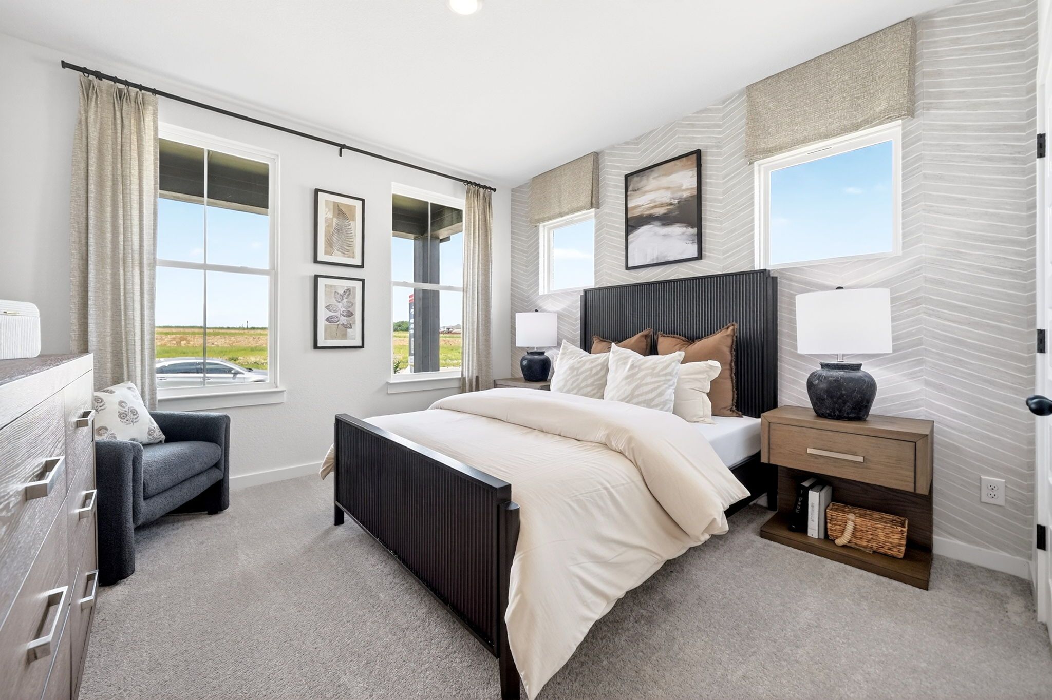 Modern primary bedroom at Parks at Foster Crossing in Anna, TX by Davidson Homes with textured wallpaper and luxe decor.
