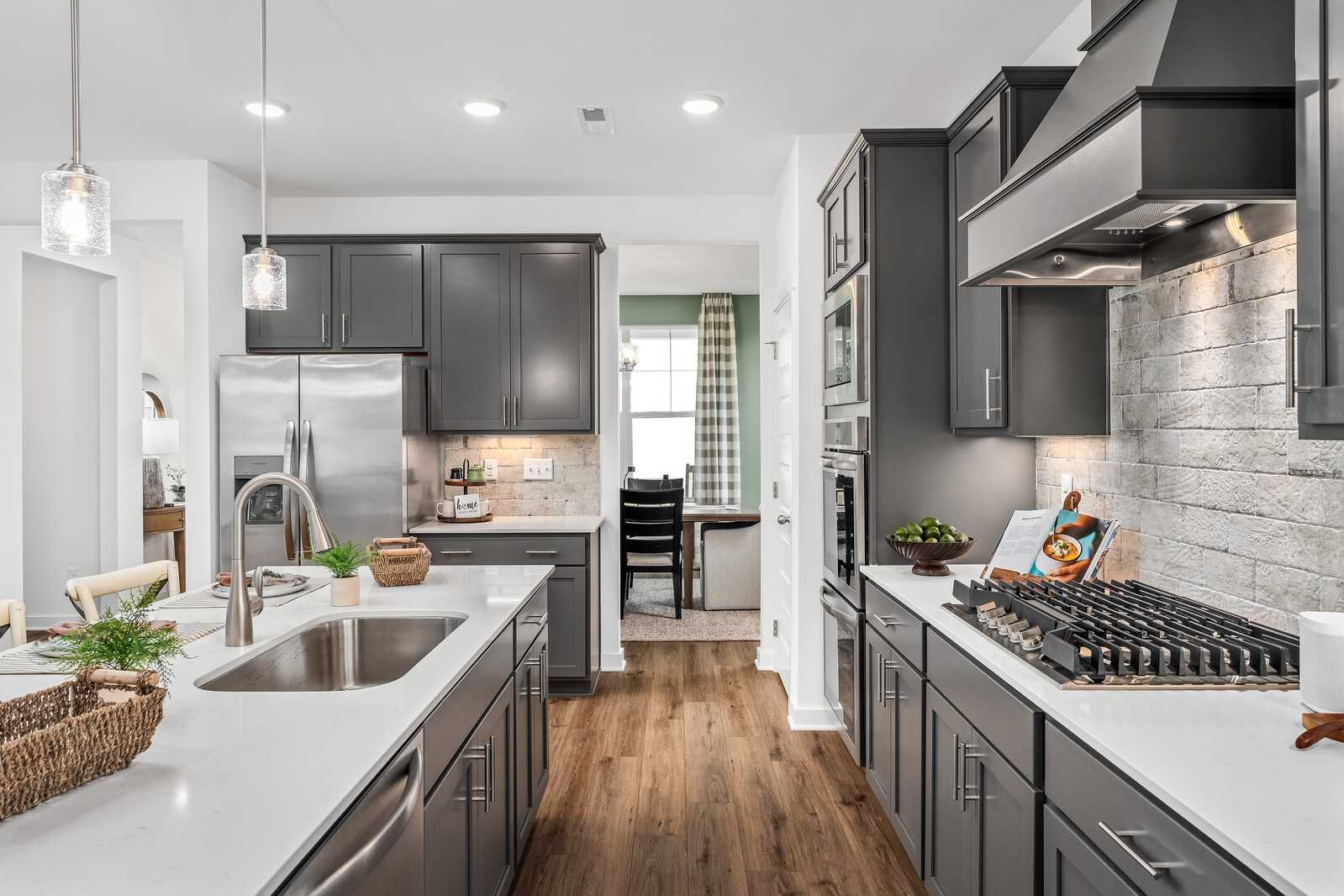 Spacious modern kitchen in Calista Farms White House TN with gray cabinets white quartz island stainless appliances