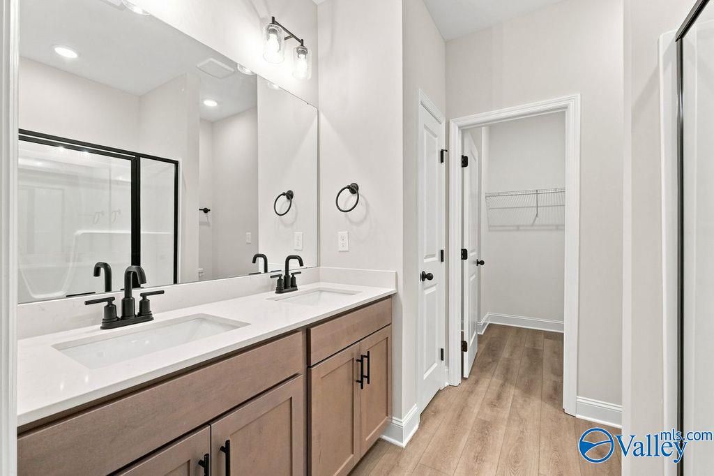Modern bathroom with double vanity and walk-in closet in The Camilla C floor plan at The Retreat at Cain Park, Hartselle.