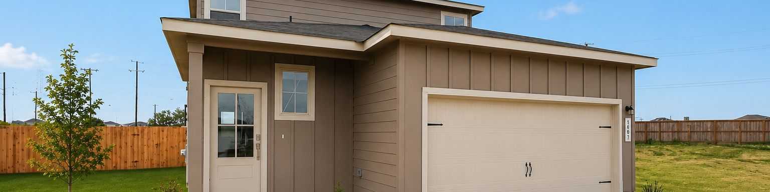 Modern home exterior at Agave in San Antonio, Texas by Davidson Homes with a two-car garage and landscaped front yard.